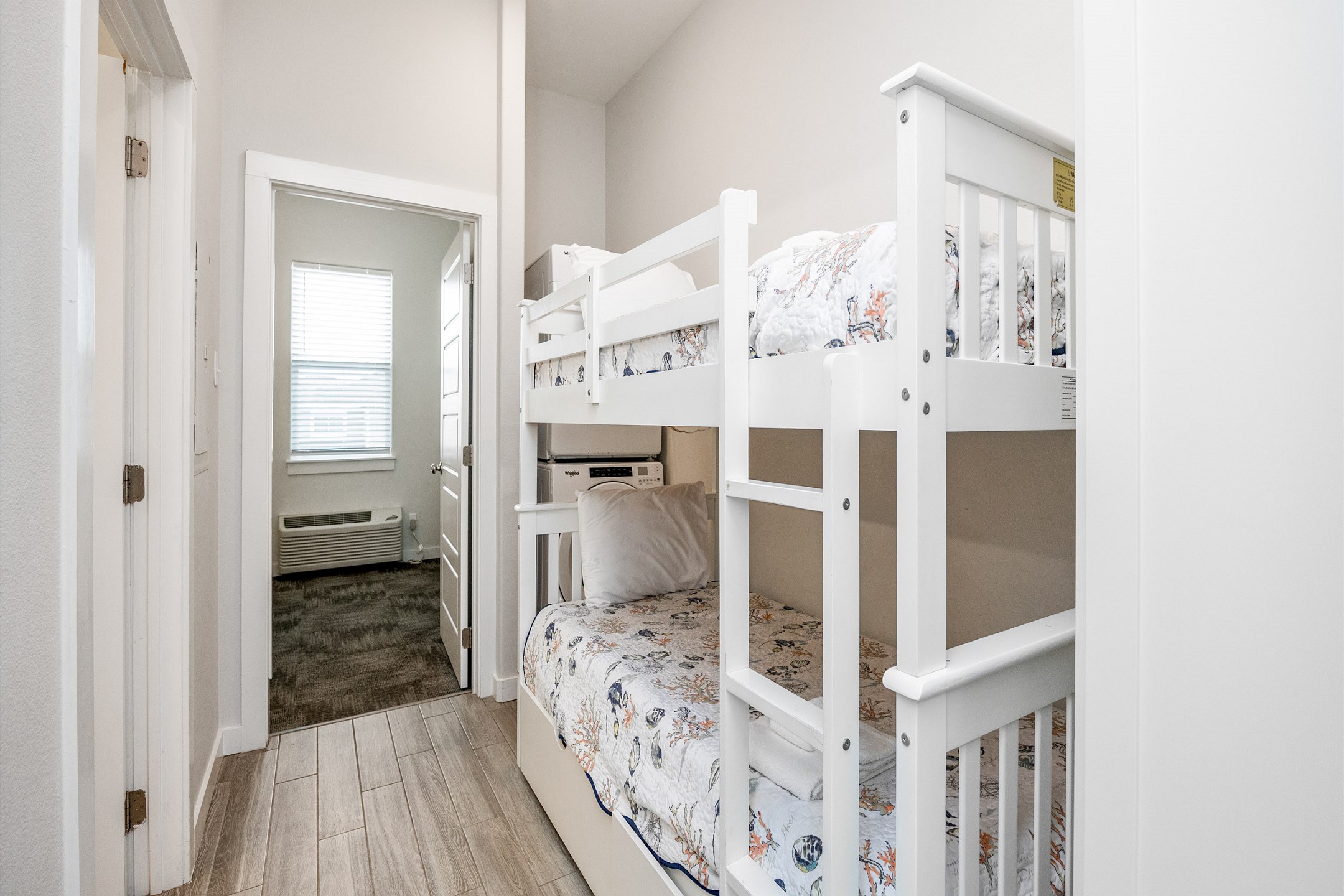 Twin size bunk beds and washer/dryer in hallway nook