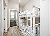 Twin size bunk beds and washer/dryer in hallway nook