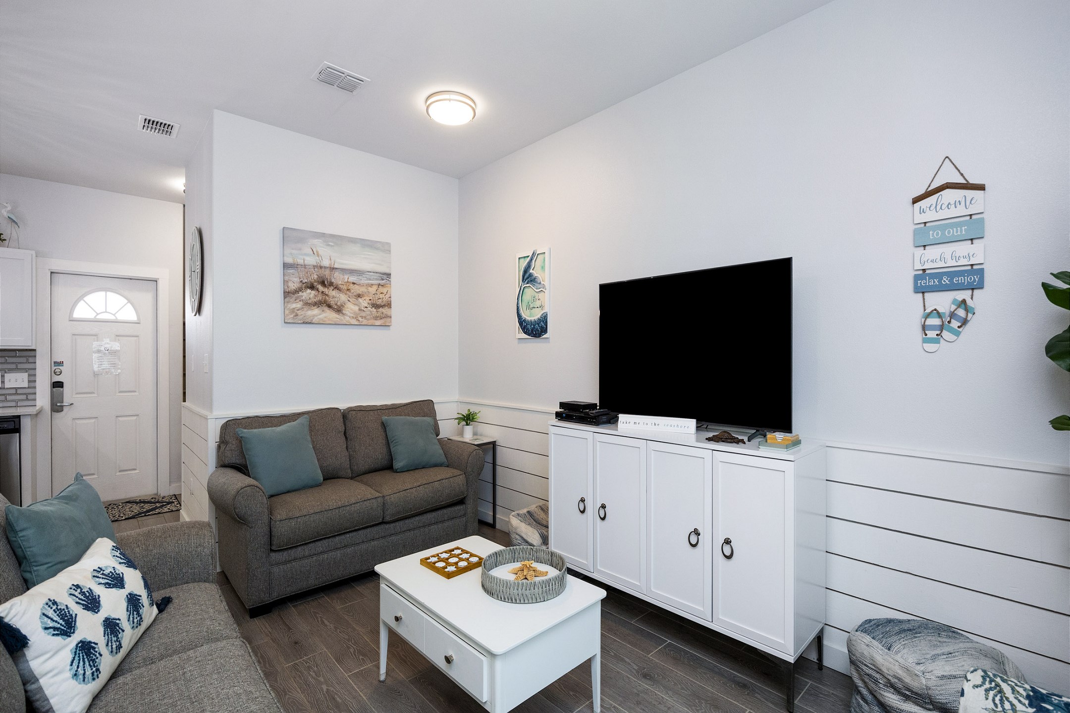 The living area features a comfy queen-size sleeper sofa and a flat screen TV—great for movie nights or extra guests.