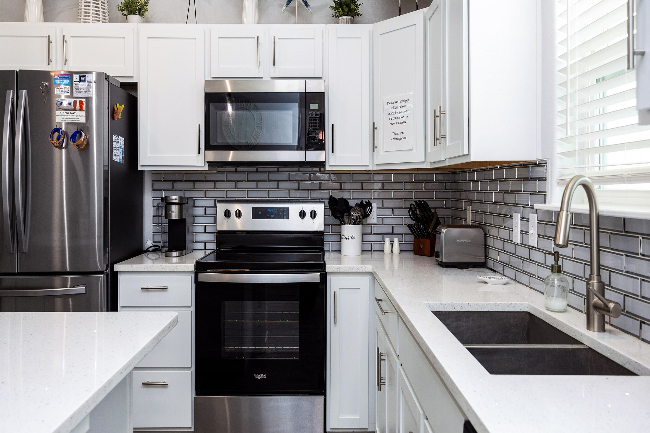 Fully equipped kitchen with coffee maker, toaster, cookware, dinnerware, and other kitchen essentials provided