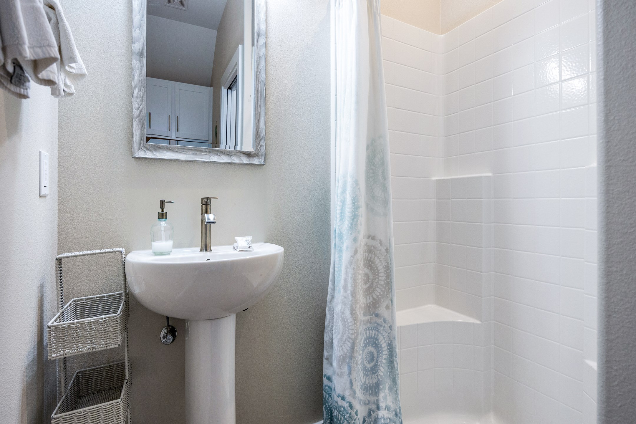 The first-floor guest bathroom features a convenient walk-in shower—ideal for rinsing off after a beach day or getting ready for a night out.