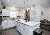 Open concept kitchen with beautiful white granite counters 
