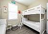 Two sets of twin size bunk beds with flat screen TV