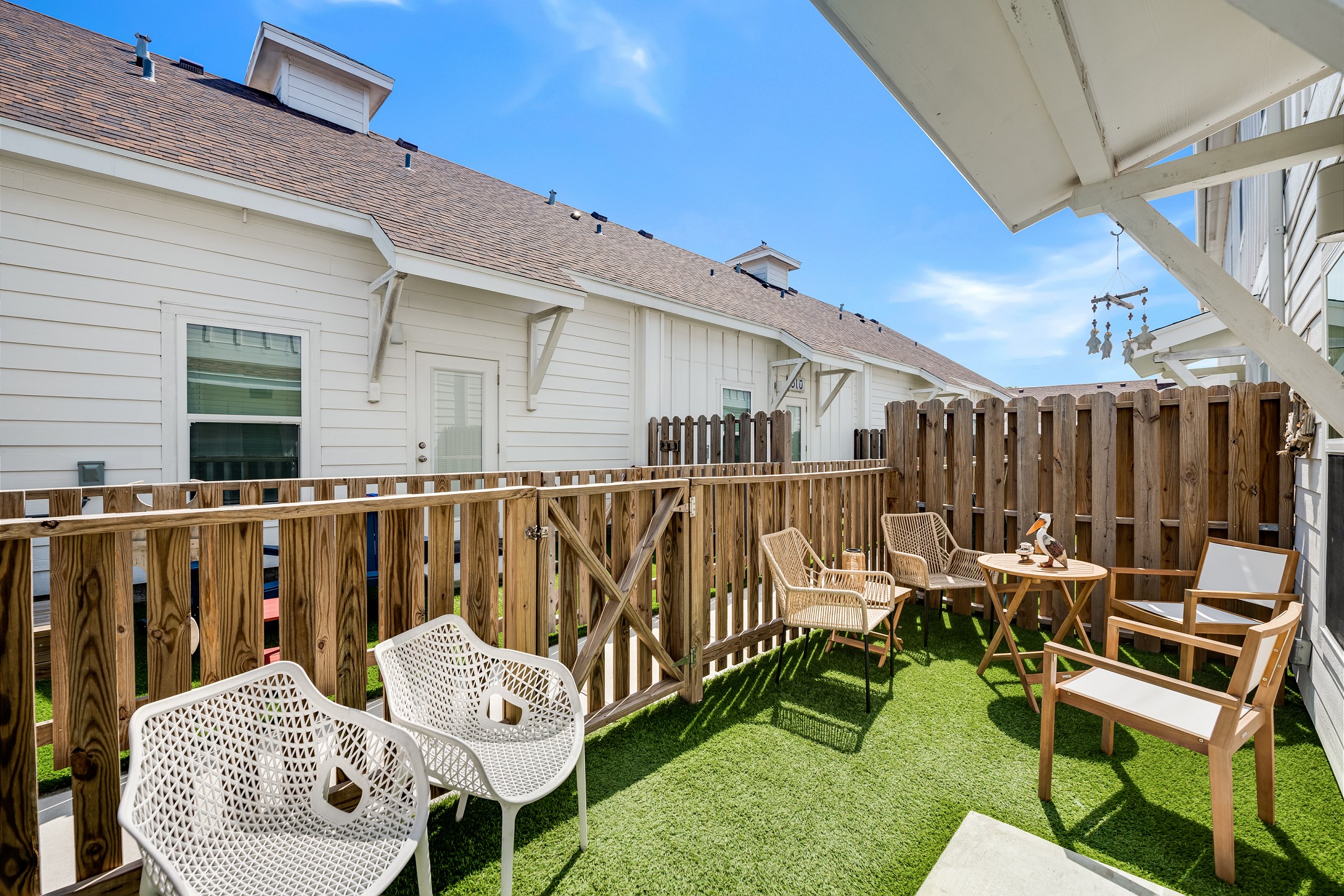 The private patio with turf grass and gated access is perfect for lounging outside or letting the kids and pups play safely.