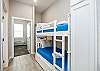 Twin size bunk beds and washer/dryer in hallway nook