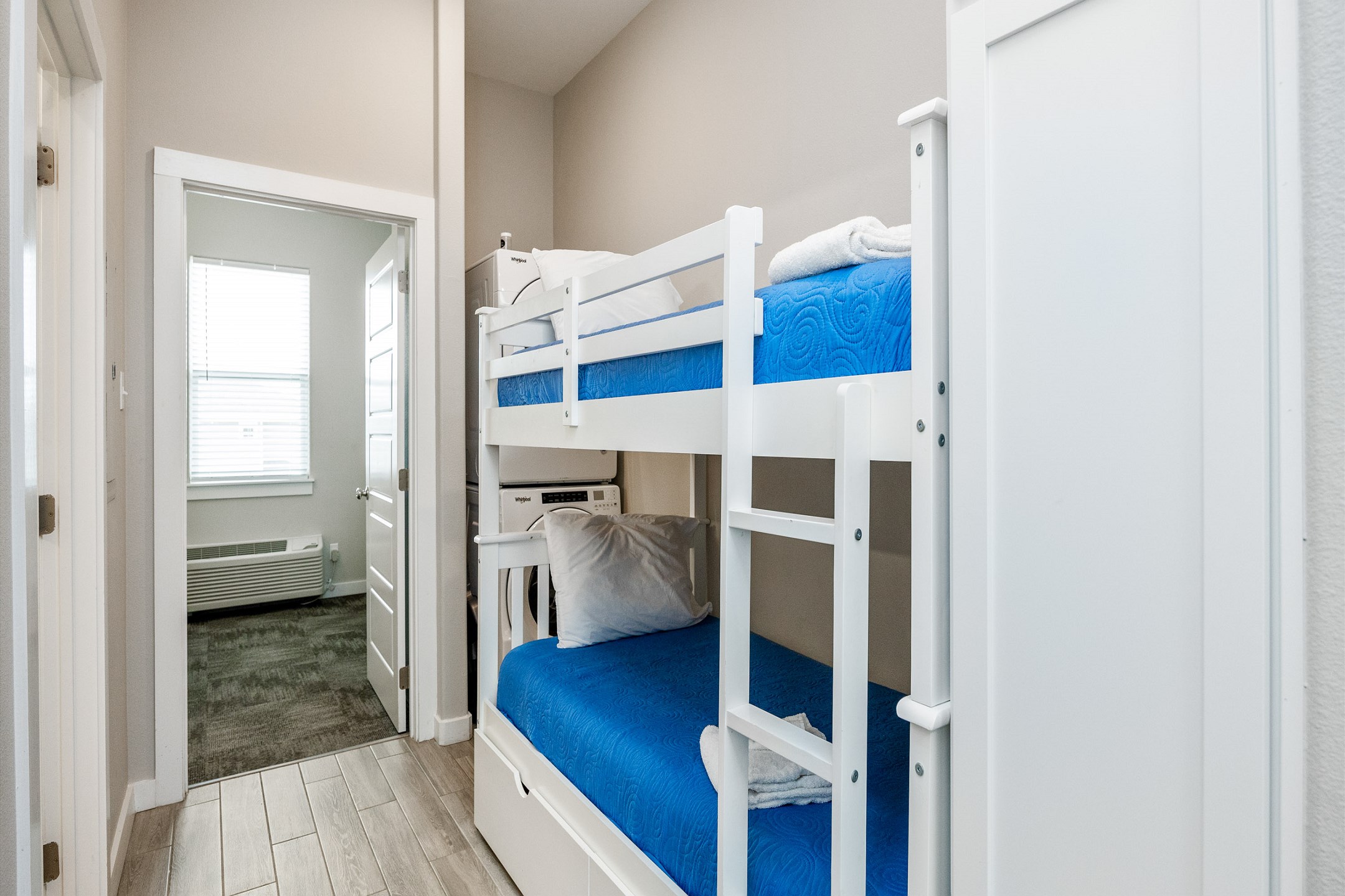 Twin size bunk beds and washer/dryer in hallway nook
