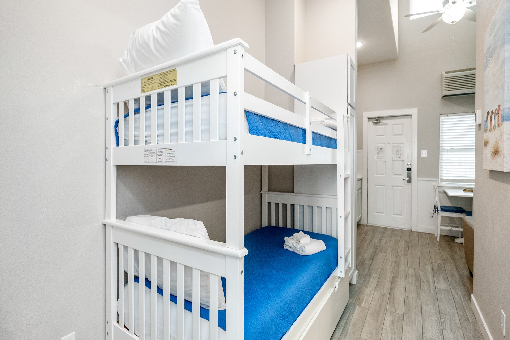 Twin size bunk beds and washer/dryer in hallway nook