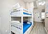 Twin size bunk beds and washer/dryer in hallway nook