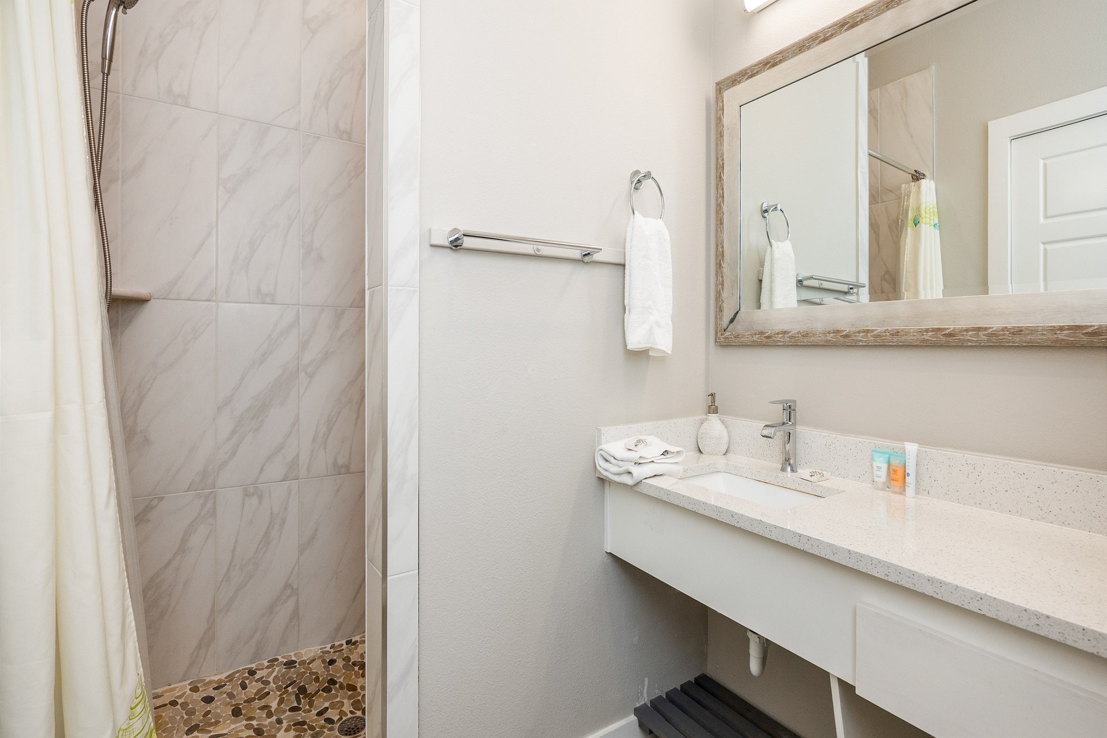 Full bathroom with sink, toilet, and walk-in tiled shower
