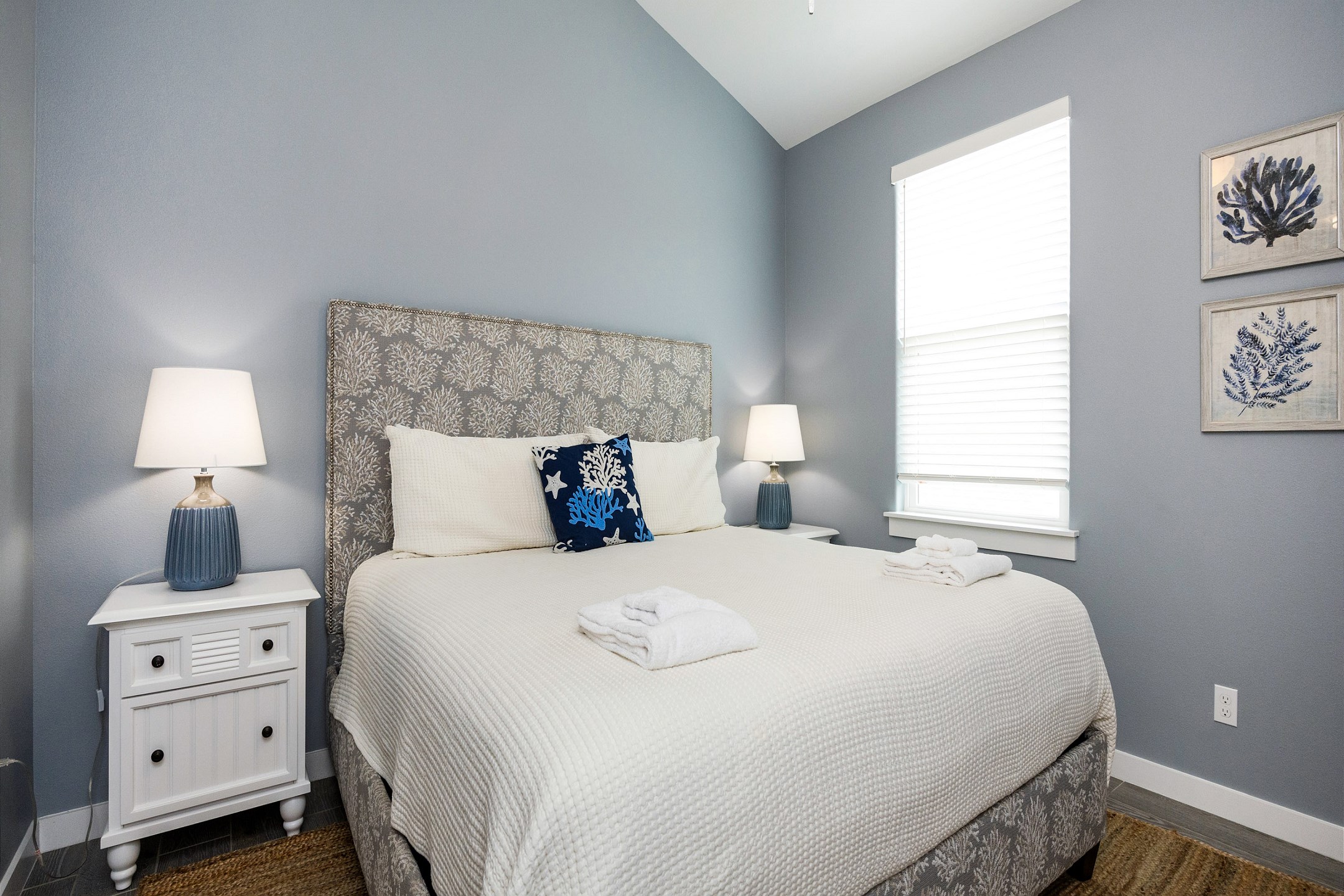 Master bedroom on the second floor with a king size bed, private bathroom, and flat screen TV