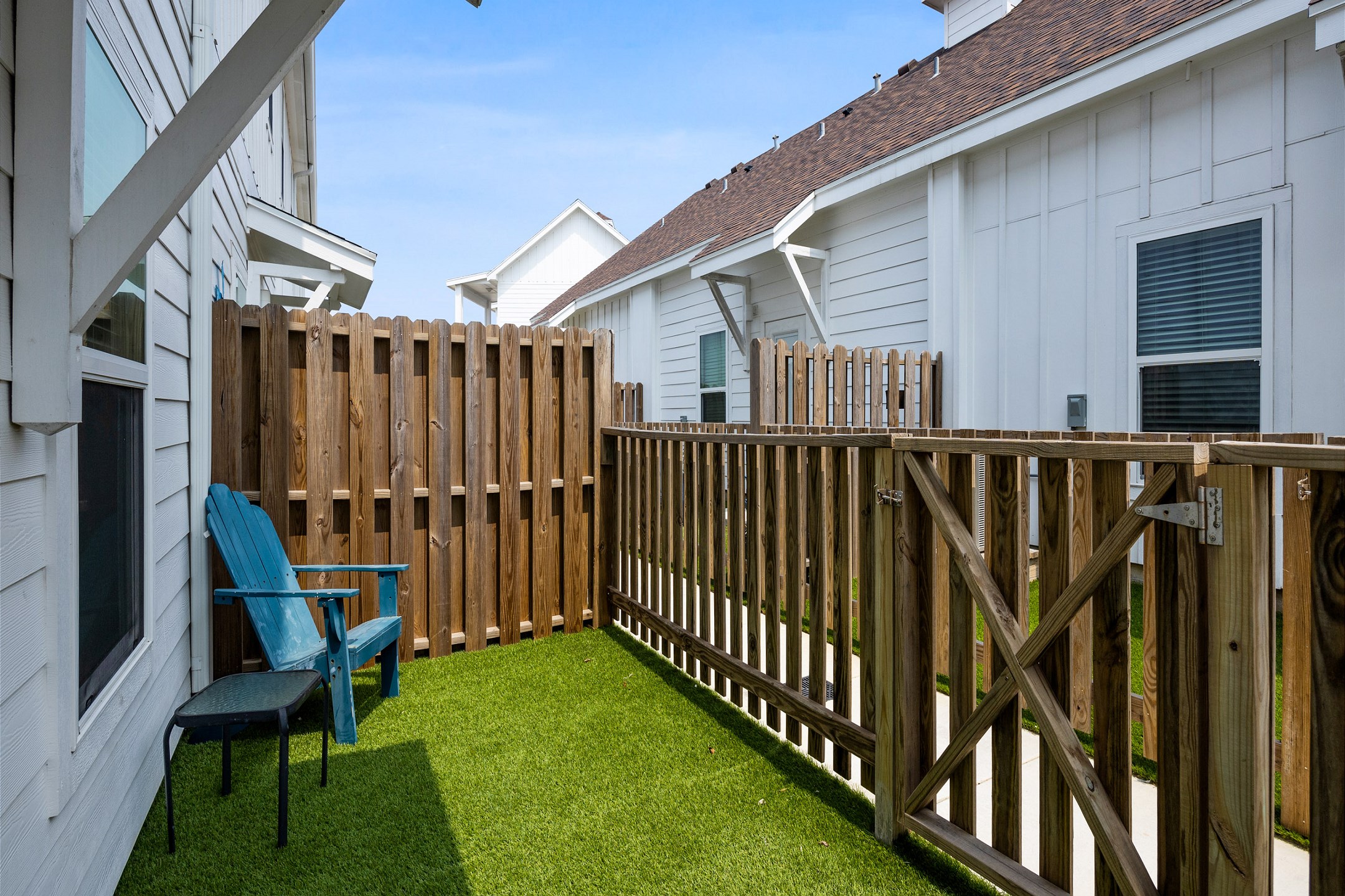 Charming back patio featuring turf grass, perfect for relaxing or entertaining