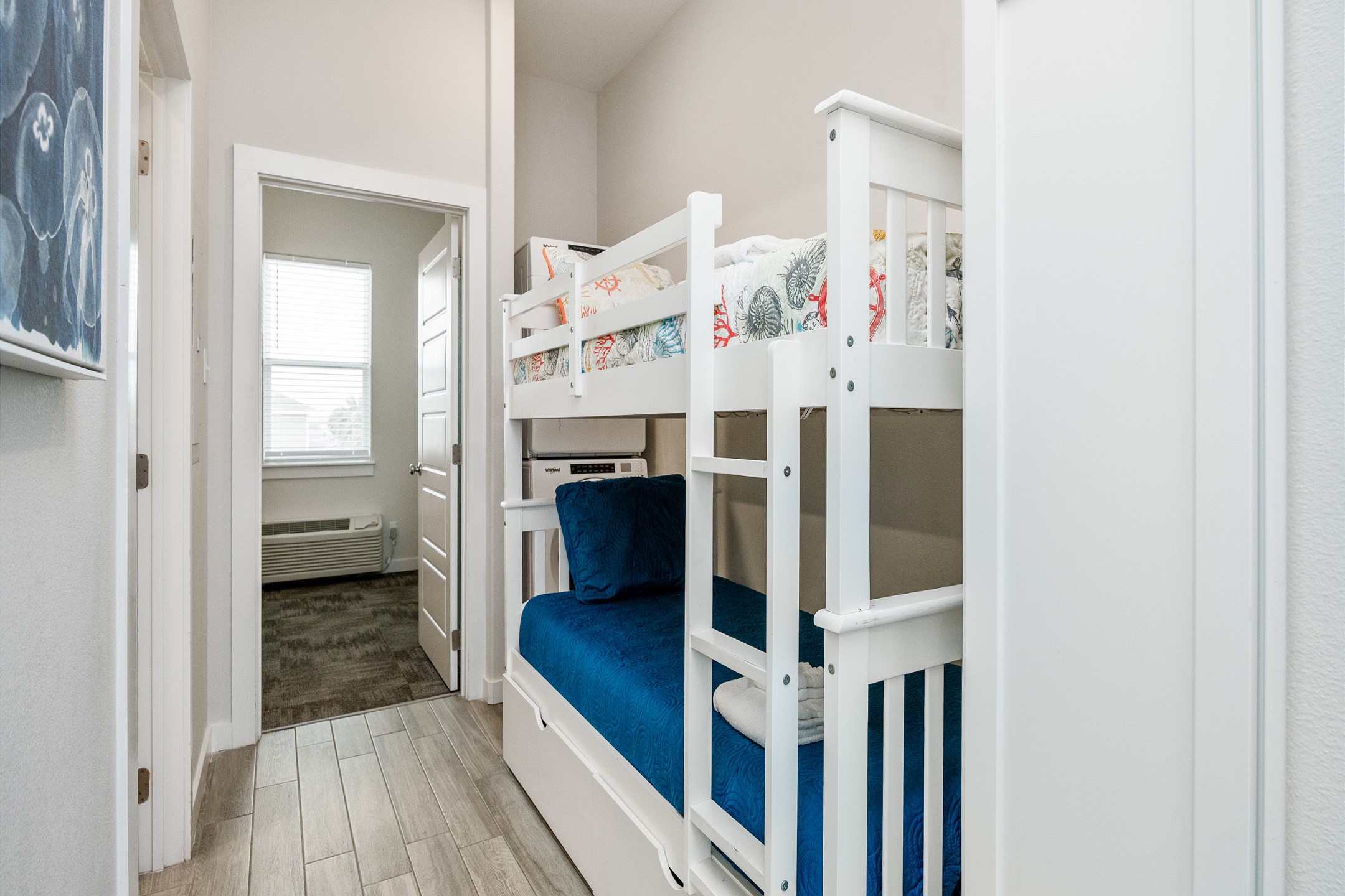 Twin size bunk beds and washer / dryer in hallway