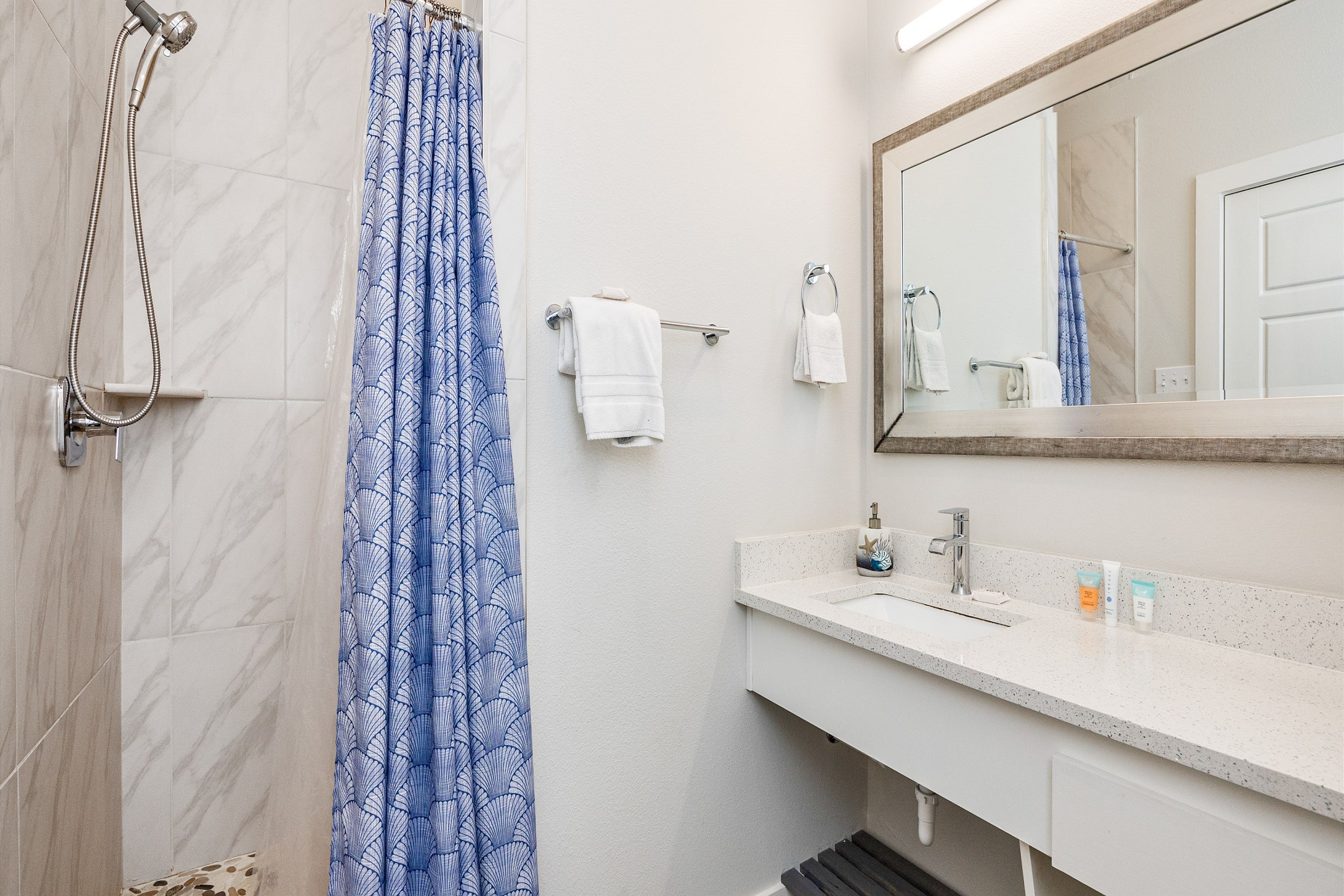 Full bathroom with single sink, toilet, and walk-in shower