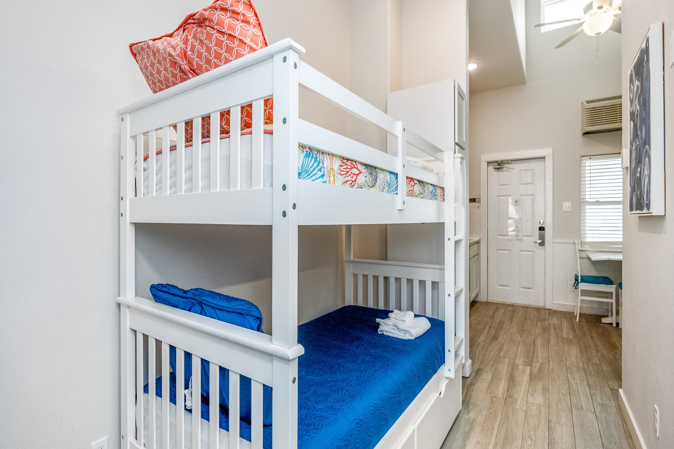 Twin size bunk beds and washer / dryer in hallway