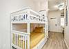 Twin size bunk beds and washer / dryer in hallway