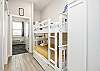 Twin size bunk beds and washer / dryer in hallway