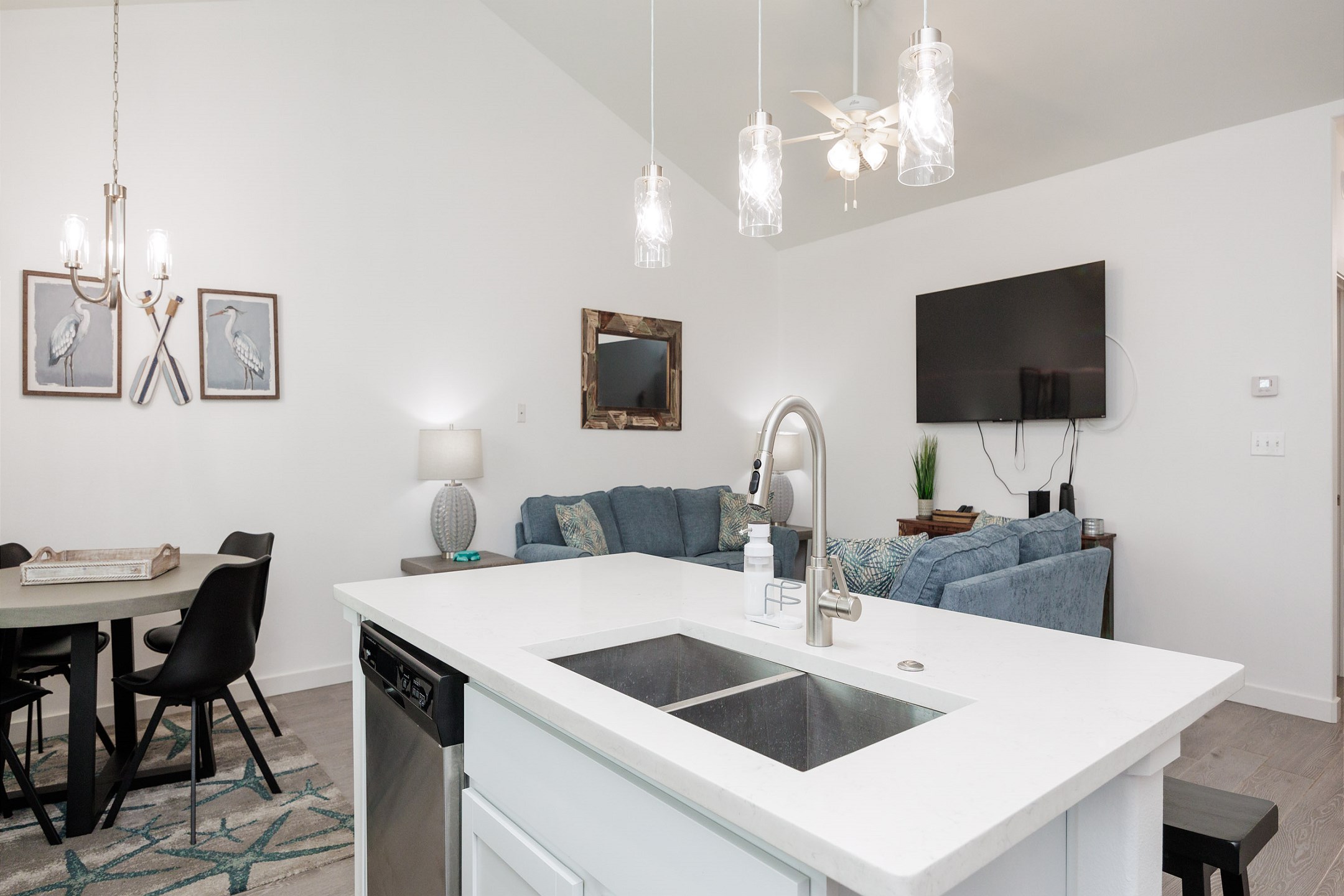 Kitchen looks into living and dining area 