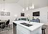 Kitchen looks into living and dining area 