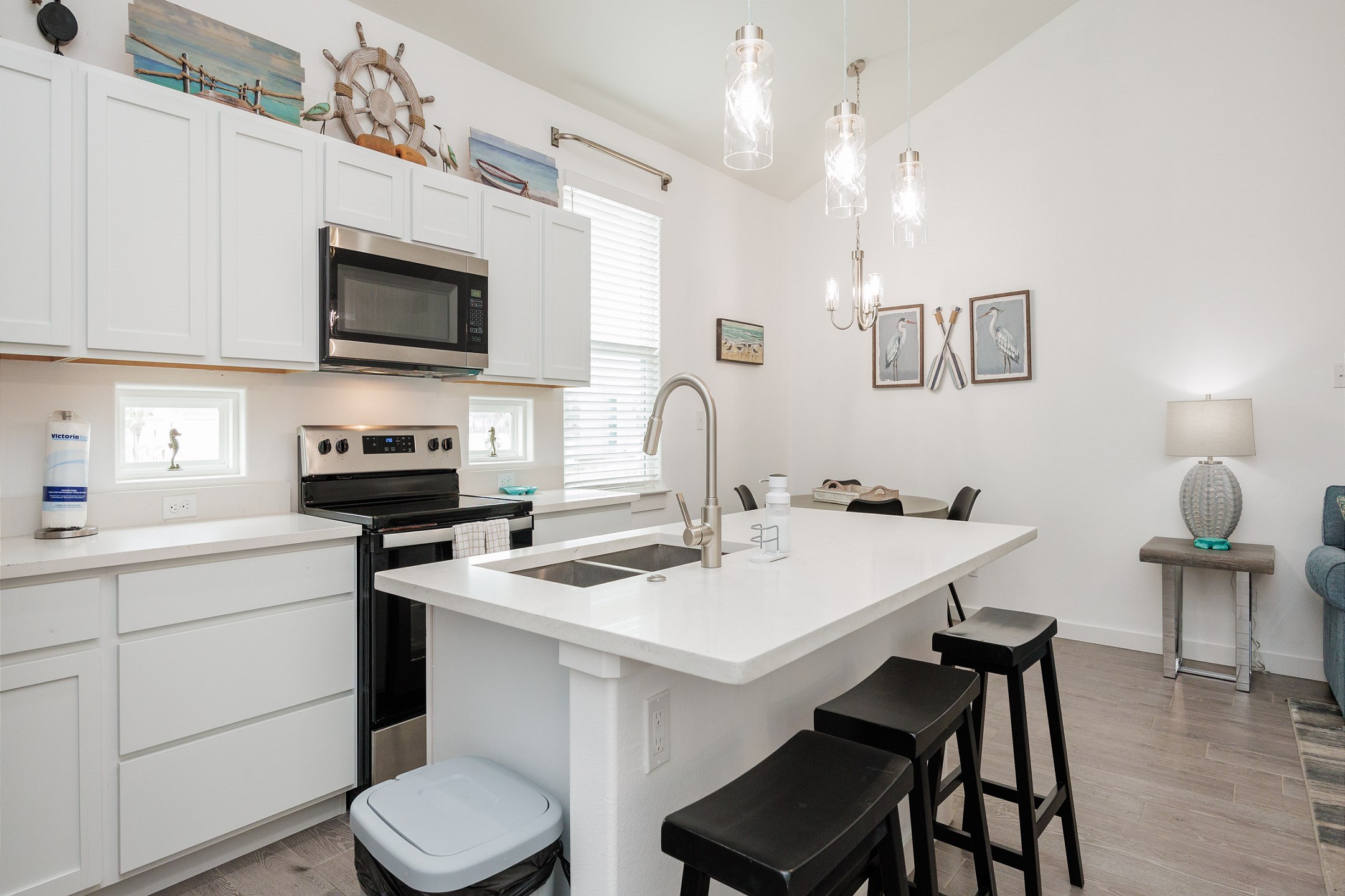 Fully equipped kitchen with stainless steel appliances and breakfast bar