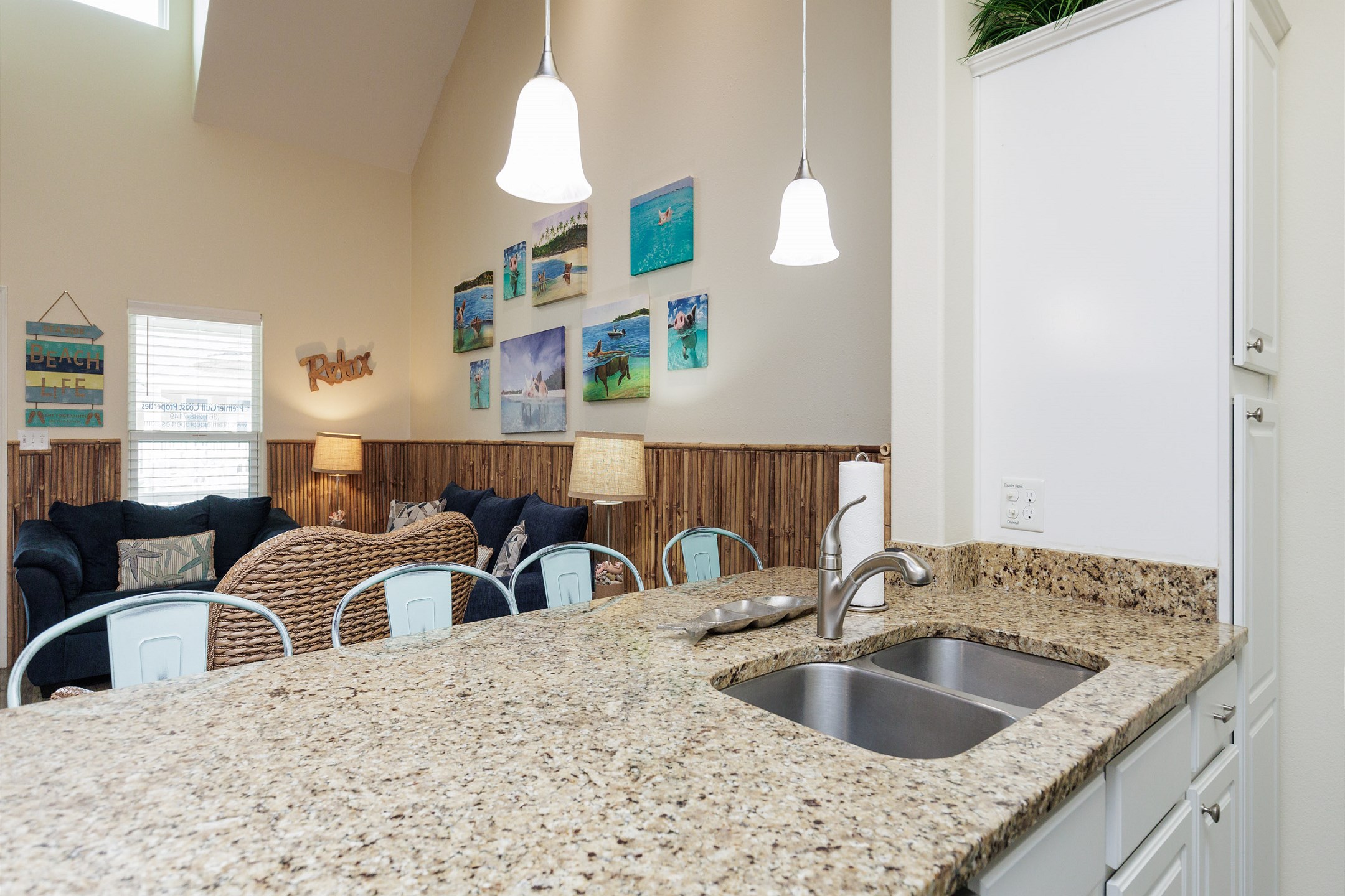 Bright kitchen with granite countertops and plenty of space designed for full meal preparation