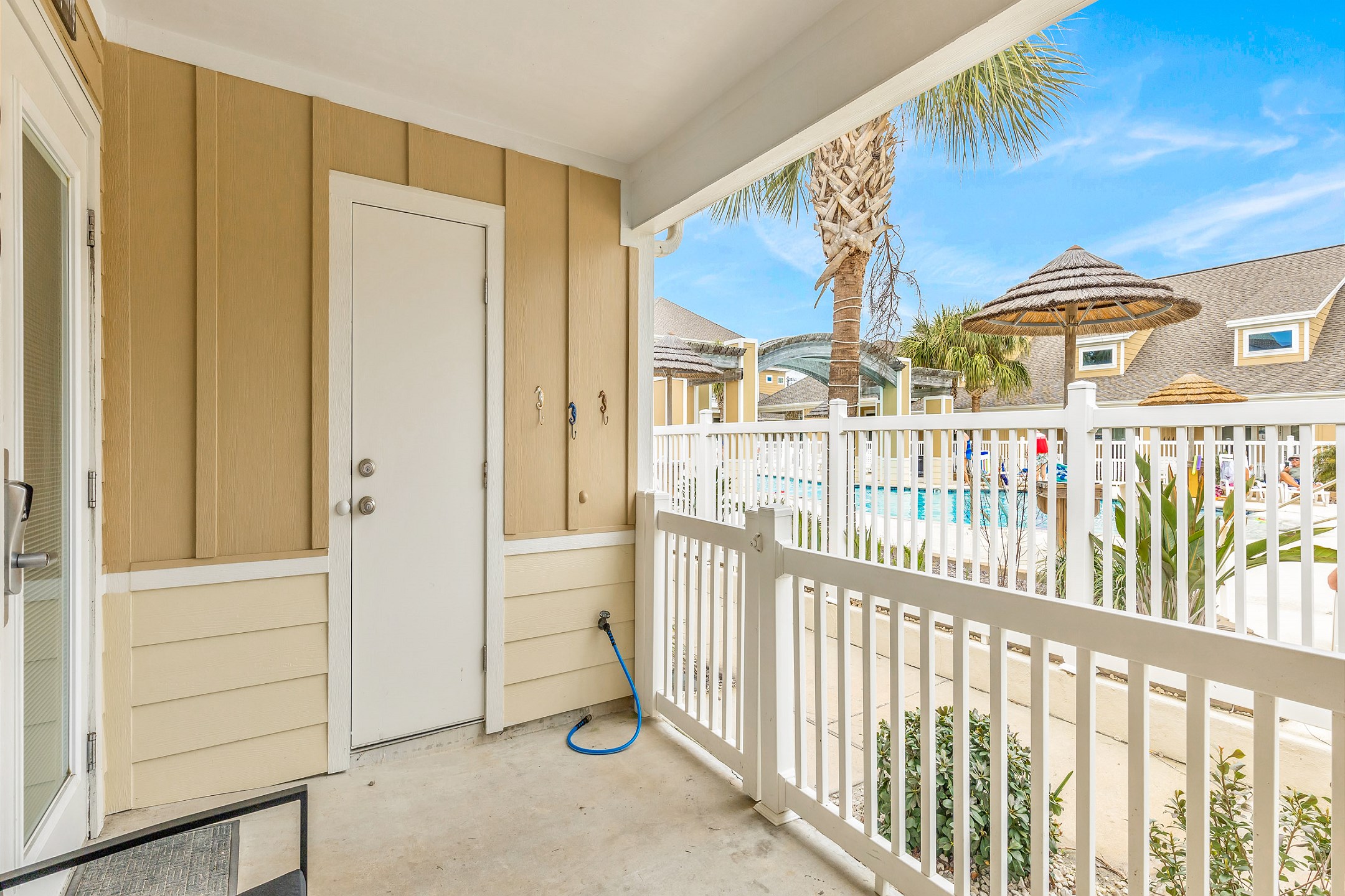 Enjoy a private patio overlooking the sparkling pool, the perfect spot to unwind while watching the kids make a splash