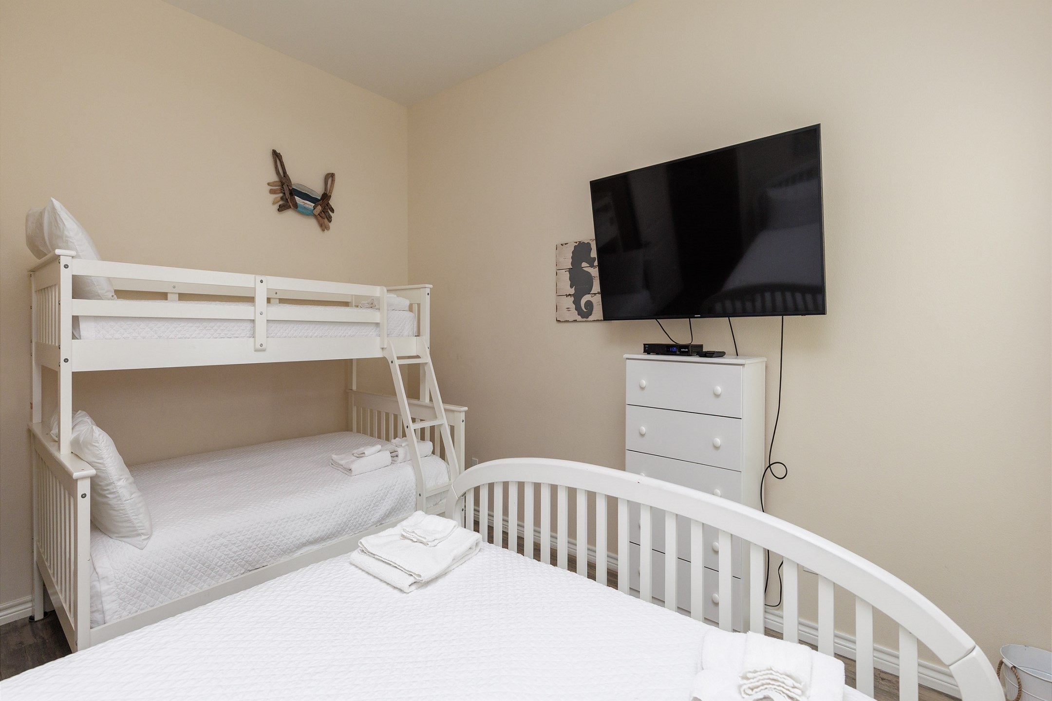 Second bedroom with queen size bed and twin over full bunk bed, along with flat screen TV