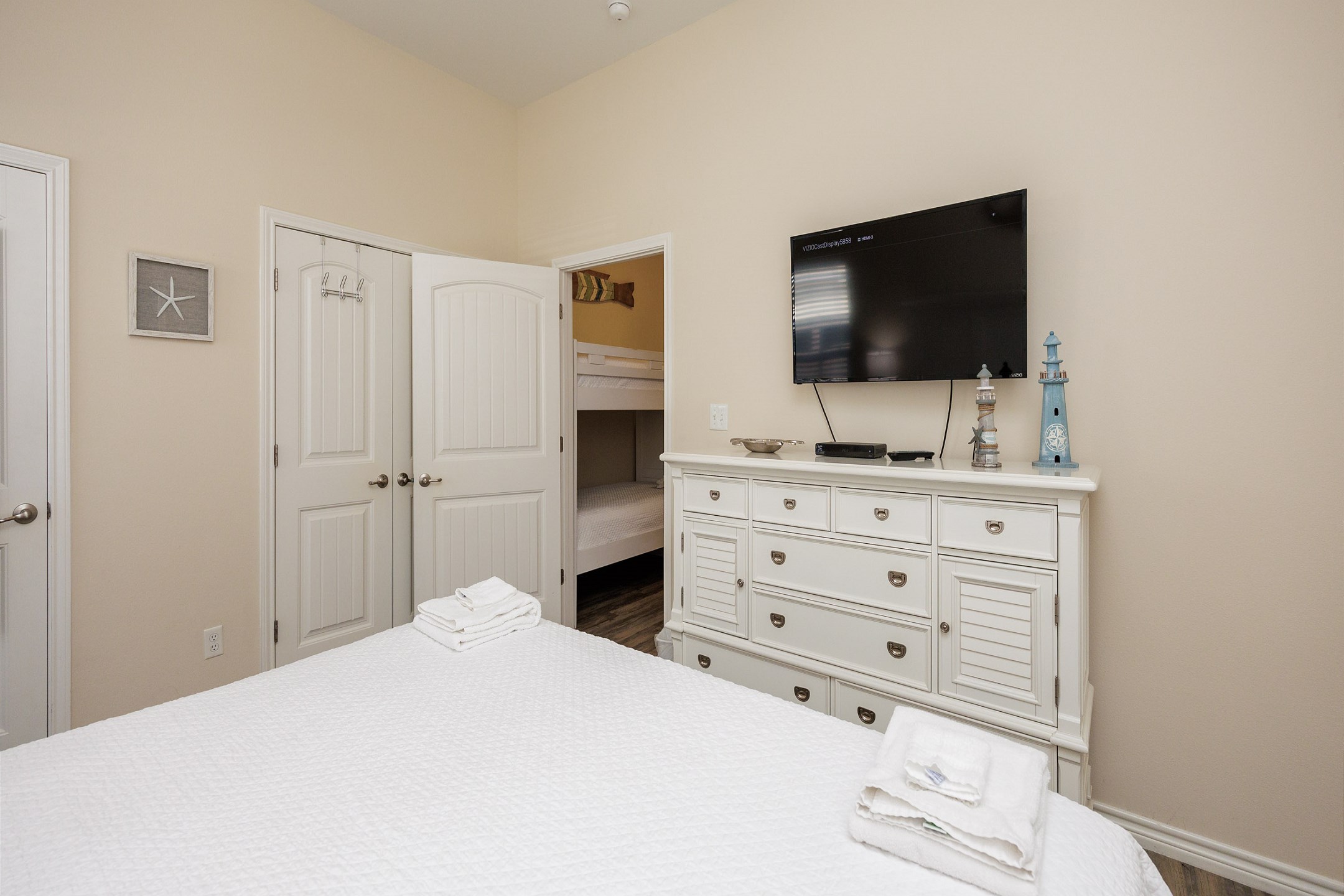 Master bedroom with king size bed and flat screen TV