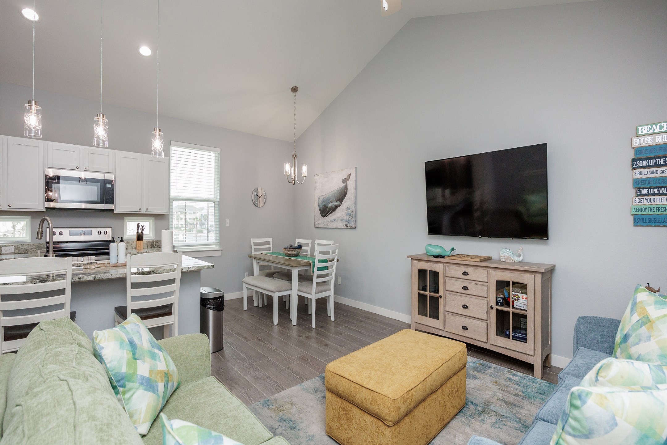 Spacious open-concept design featuring a gourmet kitchen, elegant dining area, and a comfy living room