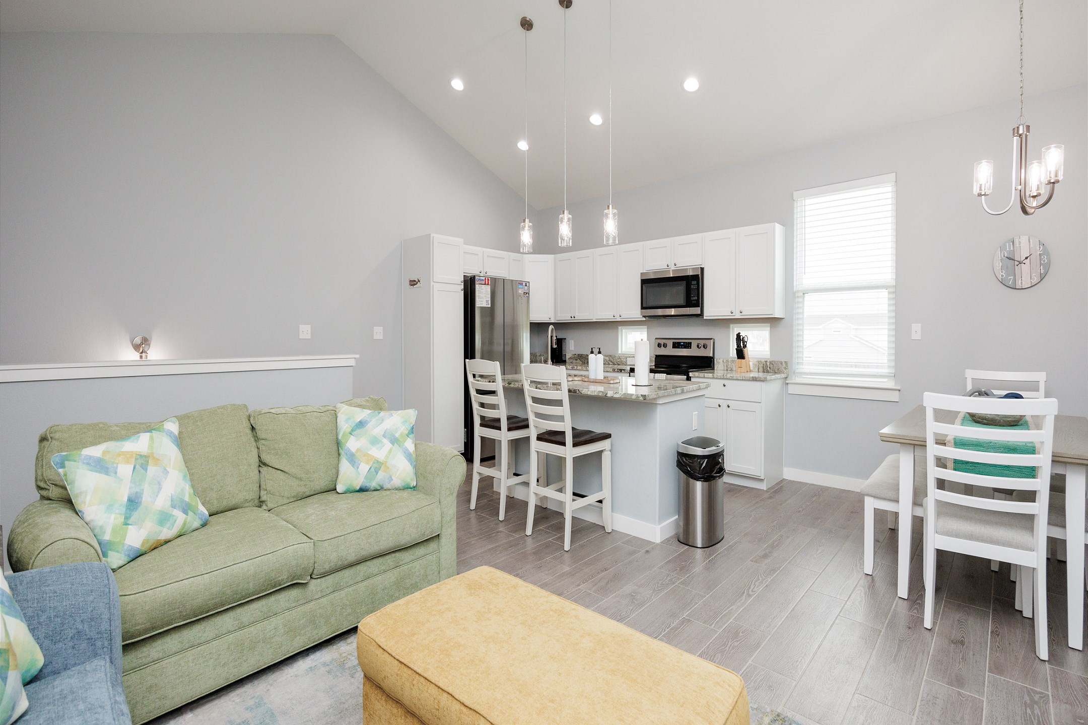 Open-concept living area with high ceilings, natural lighting, and the perfect ambiance for unwinding after a day of adventures