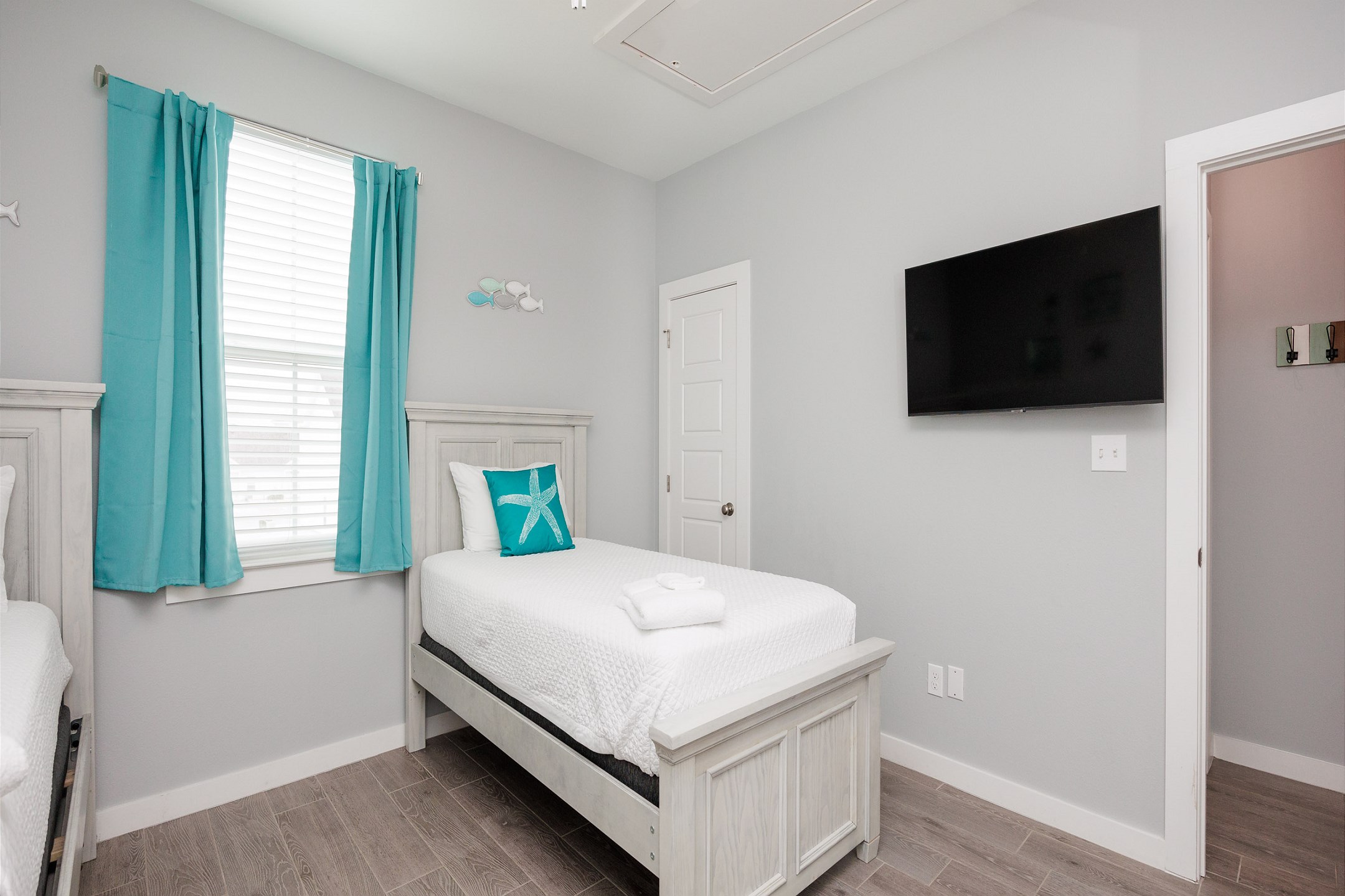 Second bedroom on the second floor with two twin size beds and a twin trundle, along with a flat screen TV