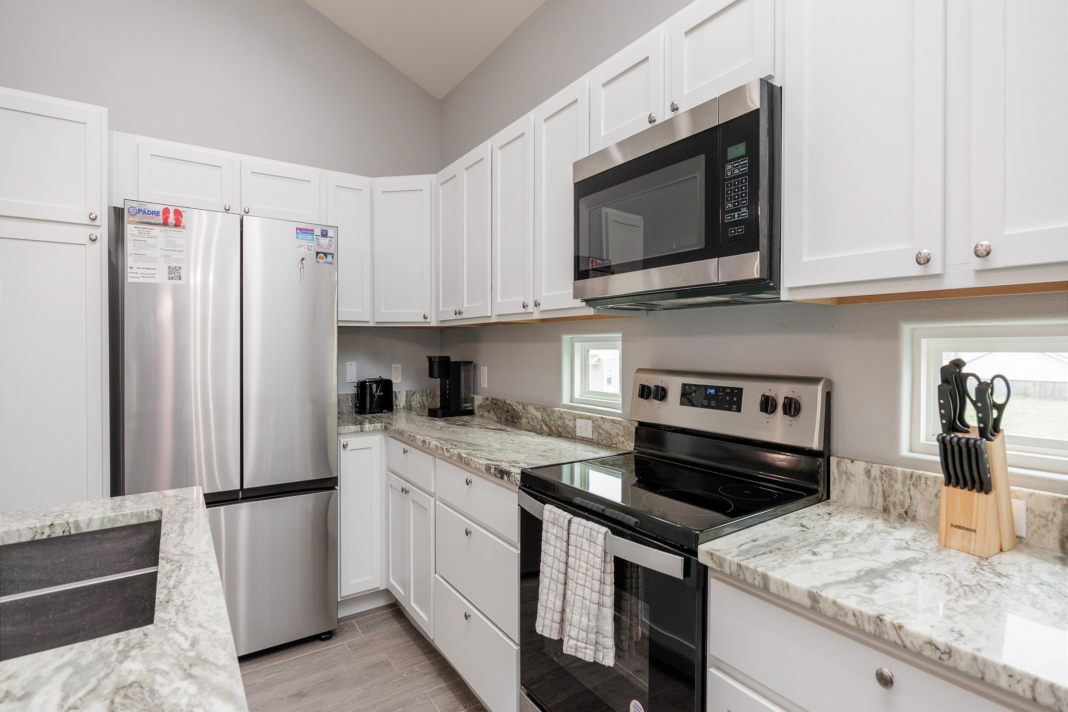 A fully stocked kitchen complete with a coffee maker, toaster, cookware, dinnerware, and all the essentials you need