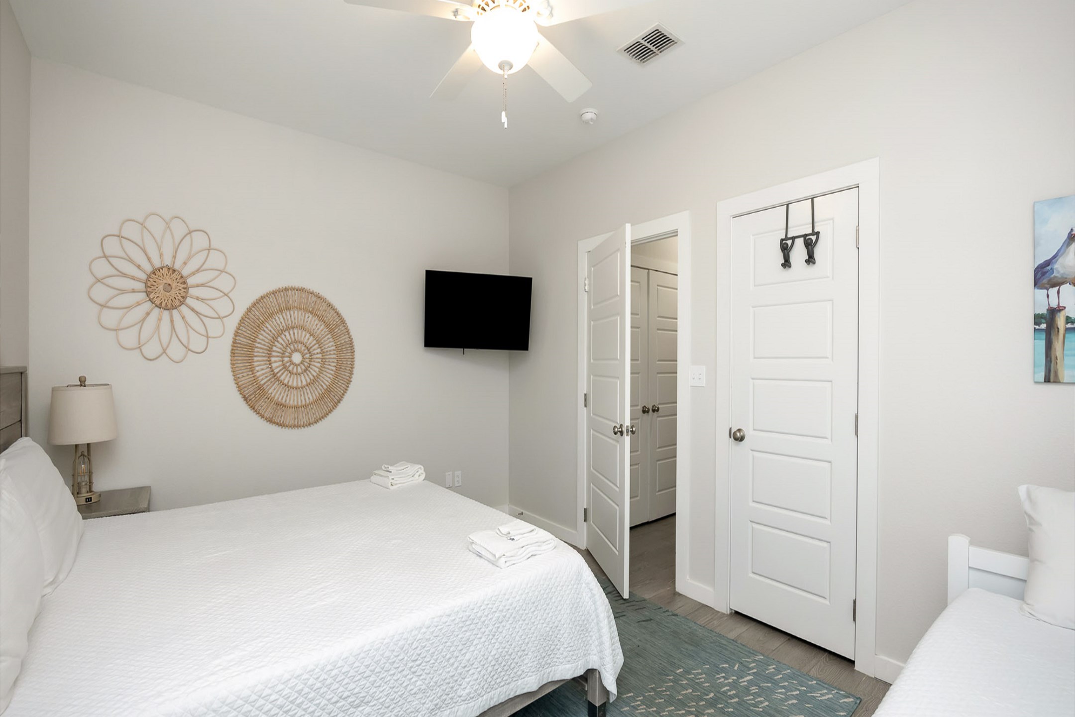 Master bedroom on the first floor with king size bed, twin daybed with trundle, back patio access, private bathroom and flat screen TV