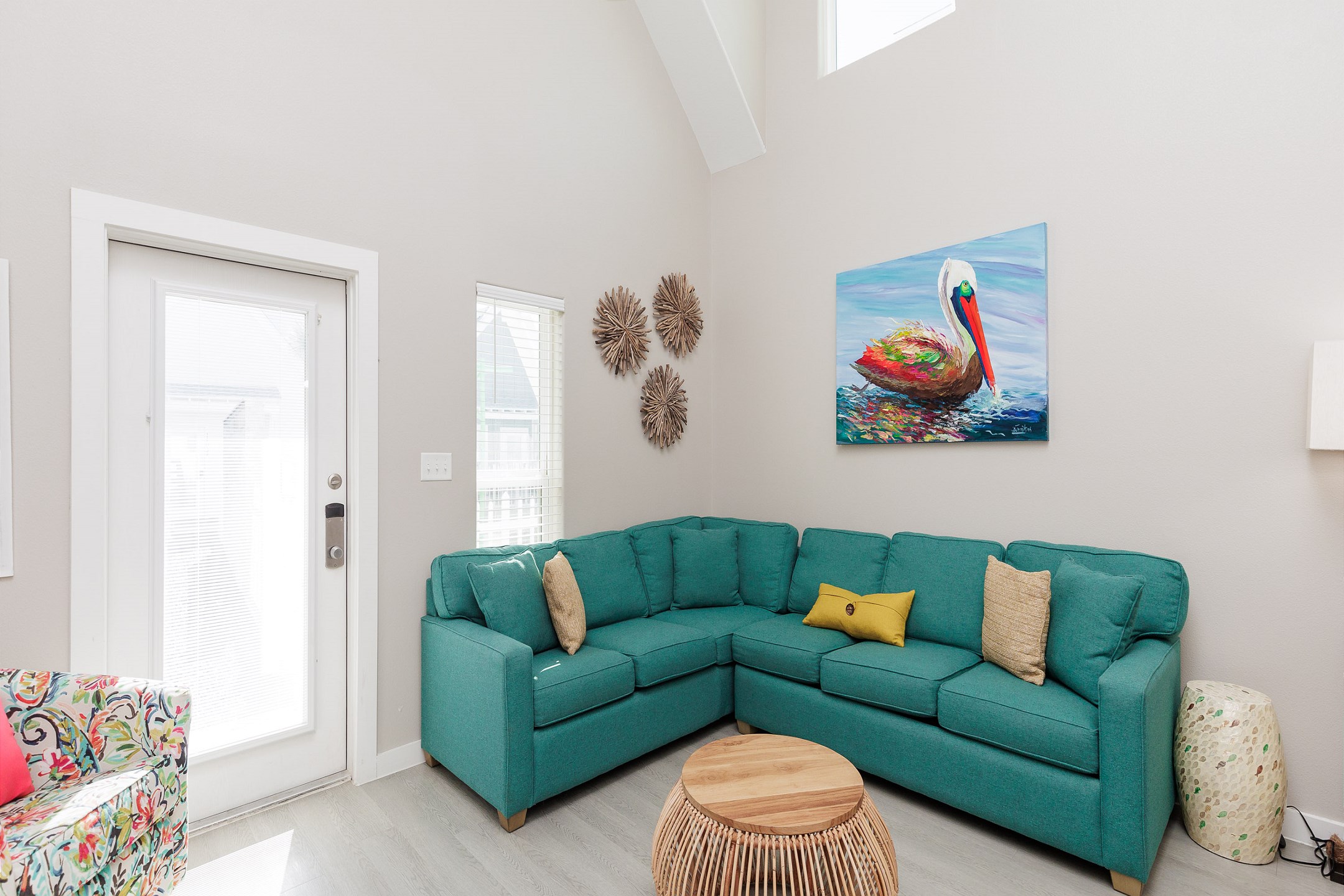 Living area with high ceilings, bright lighting, and a queen sleeper sofa