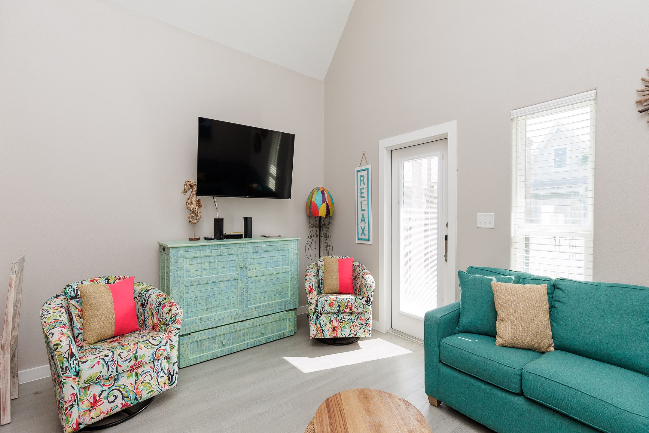 Comfortable living area featuring a queen-size sleeper sofa, queen credenza and a flat-screen TV for your entertainment