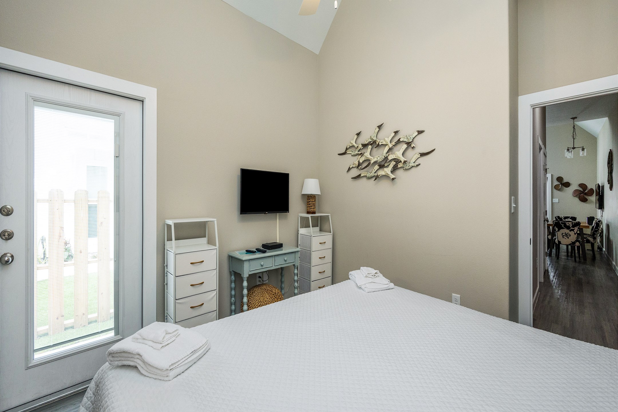 Master bedroom with king size bed, private bathroom, along with a flat screen TV and exterior access