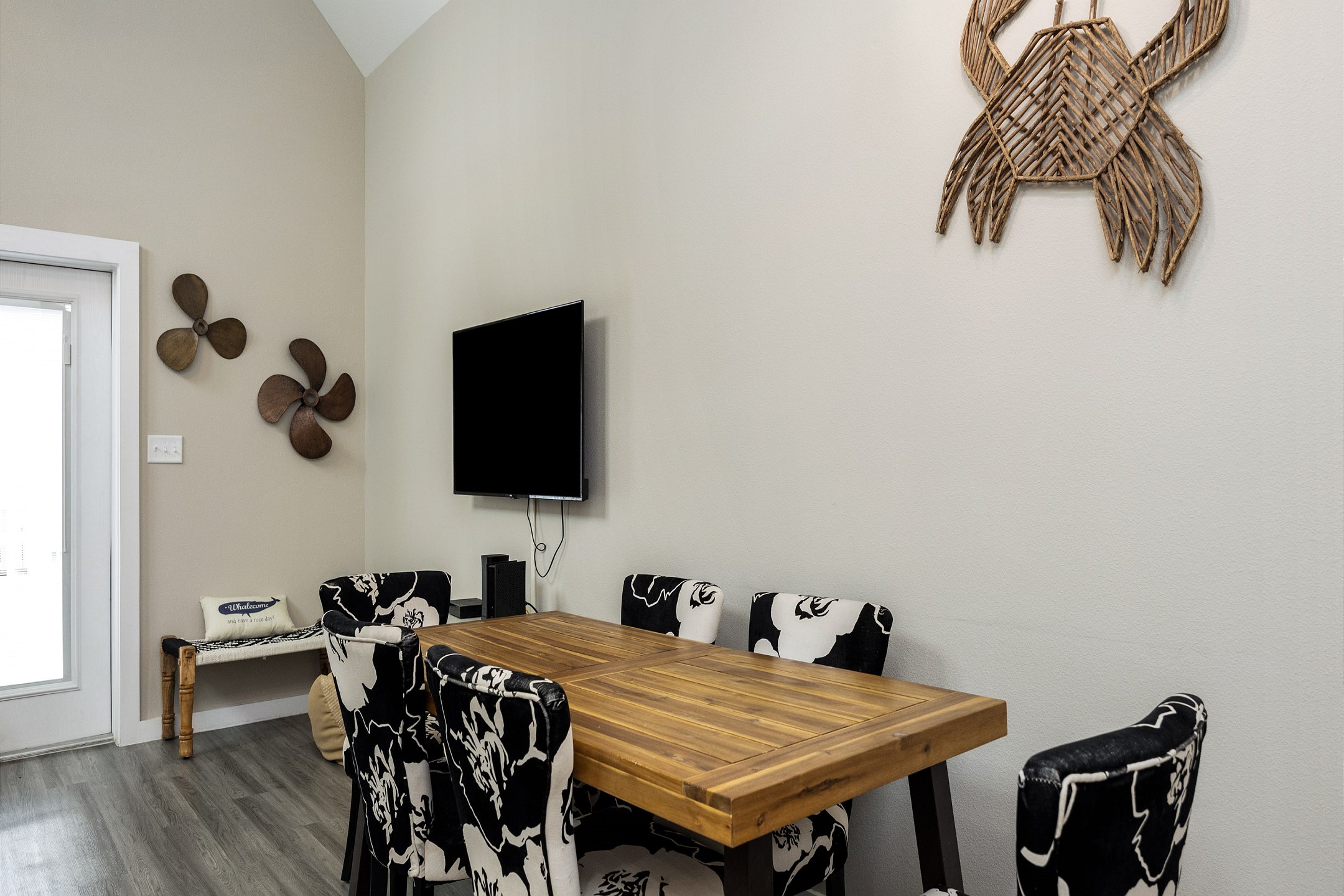 Quaint dining space with beach-themed artwork