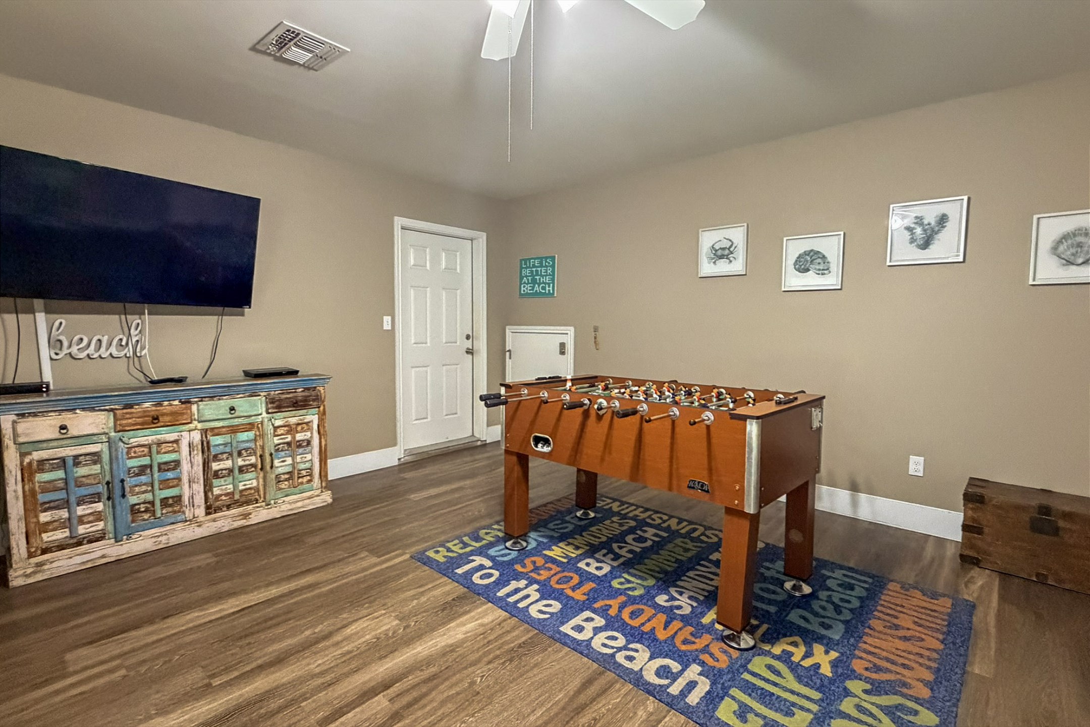 First floor media room with four twin size beds, flat screen TV and foosball table to enjoy