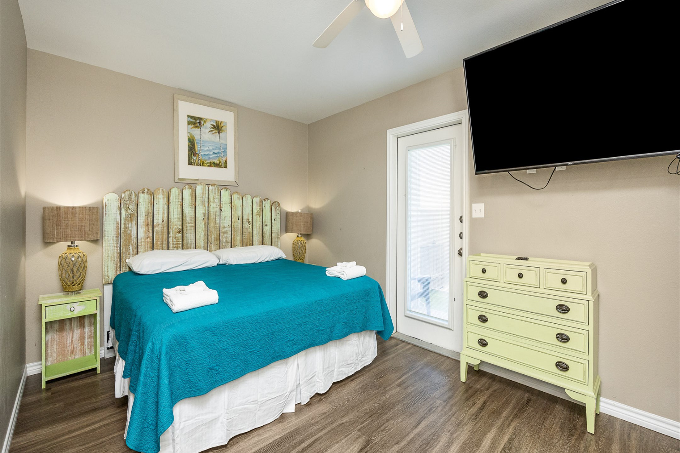 Master bedroom on the first floor with king size bed, twin day bed and twin trundle, access to private patio, private bathroom and flat screen TV