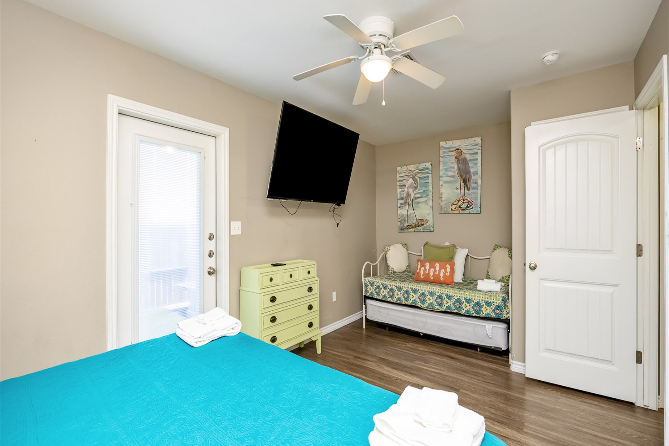 Master bedroom on the first floor with king size bed, twin day bed and twin trundle, access to private patio, private bathroom and flat screen TV