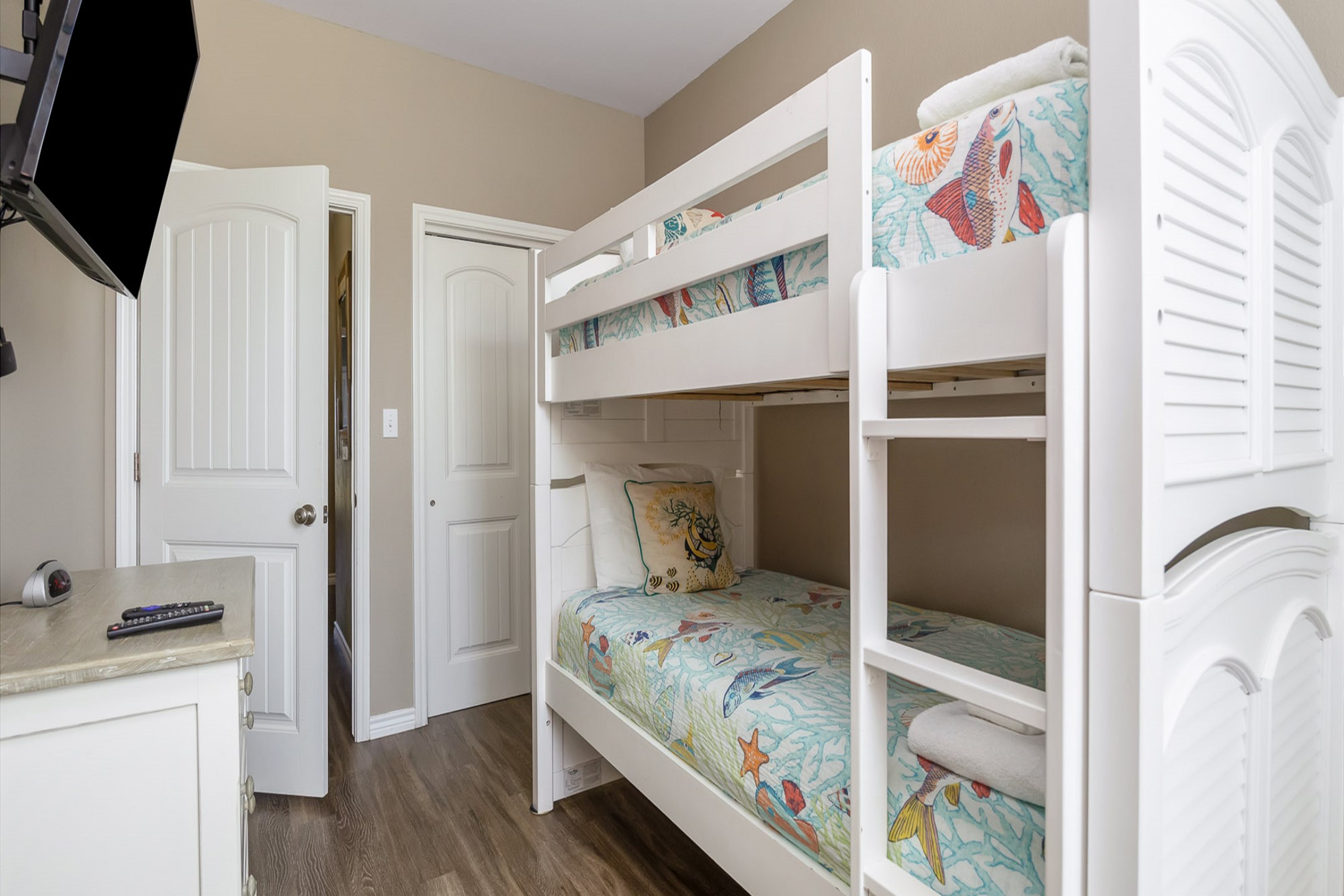 Fourth bedroom on the second floor with twin over twin size bunk bed, shared bathroom and flat screen TV