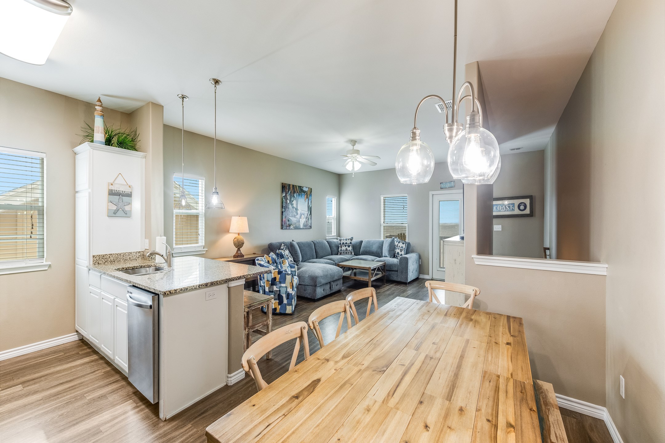 Open-plan living zone with cozy seating and flat screen TV to enjoy with the family