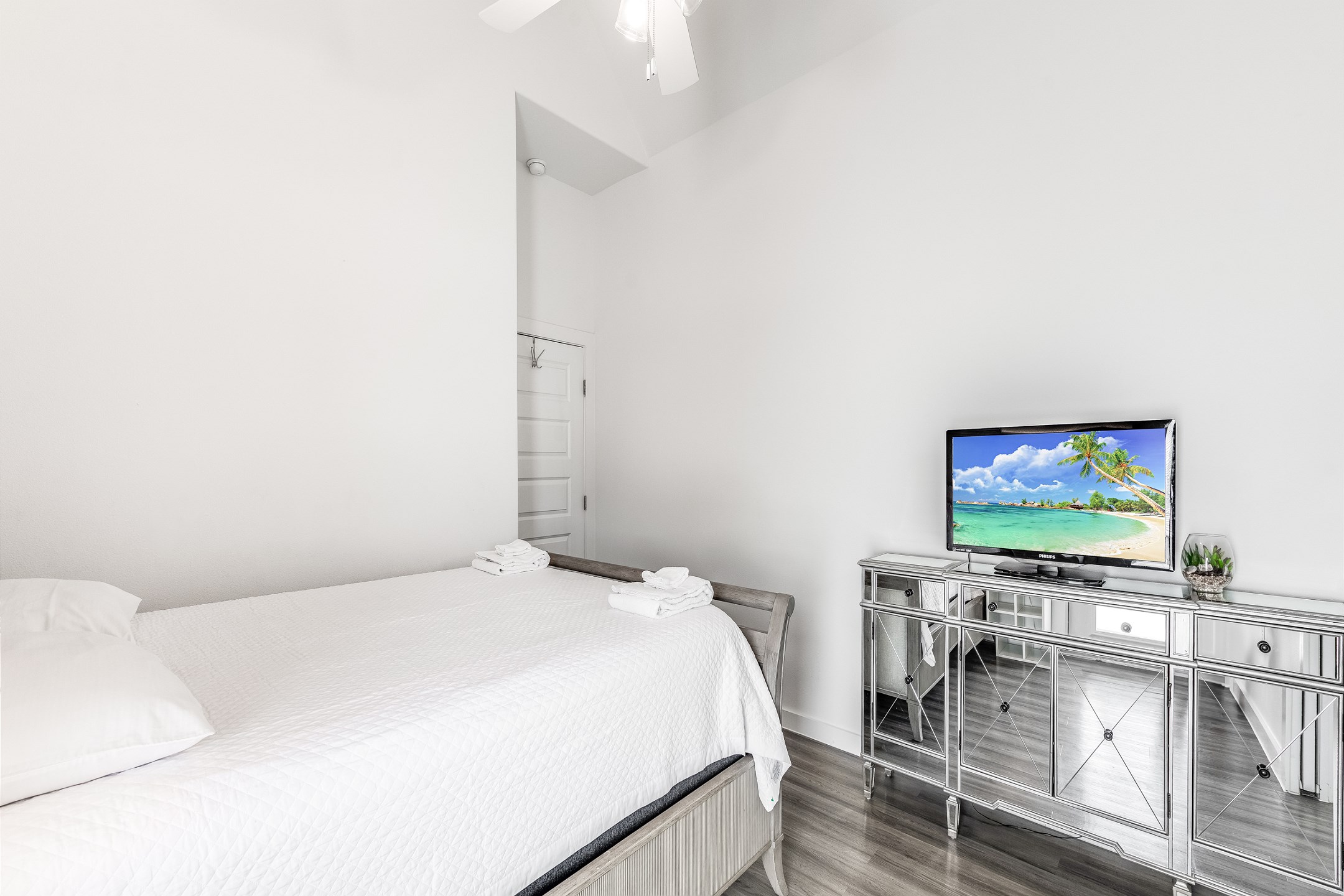 Master bedroom with queen size bed, private bathroom, and flat screen TV