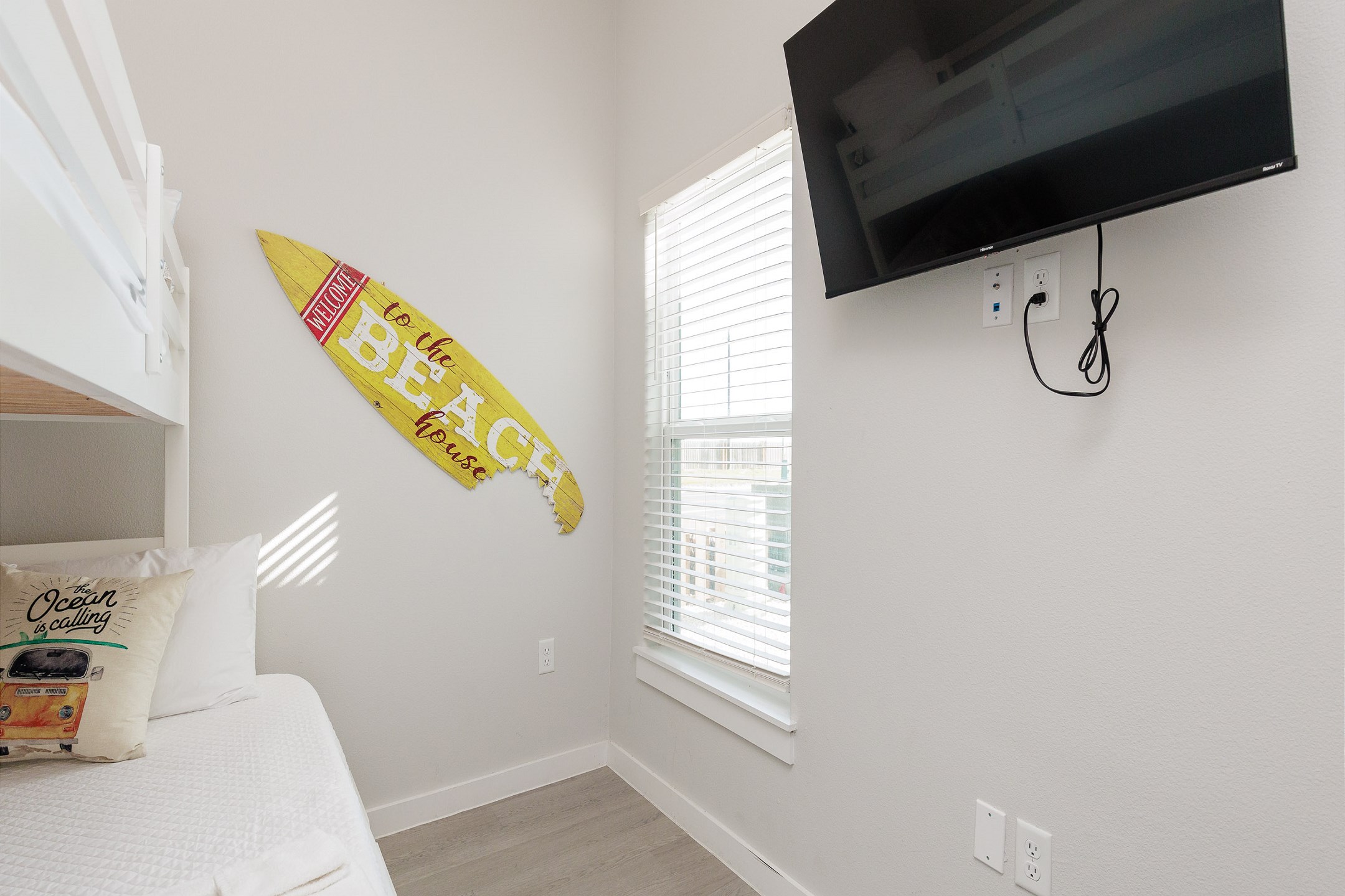 Second bedroom with twin over full size bunk bed with twin trundle, flat screen TV and surfing themed decor 