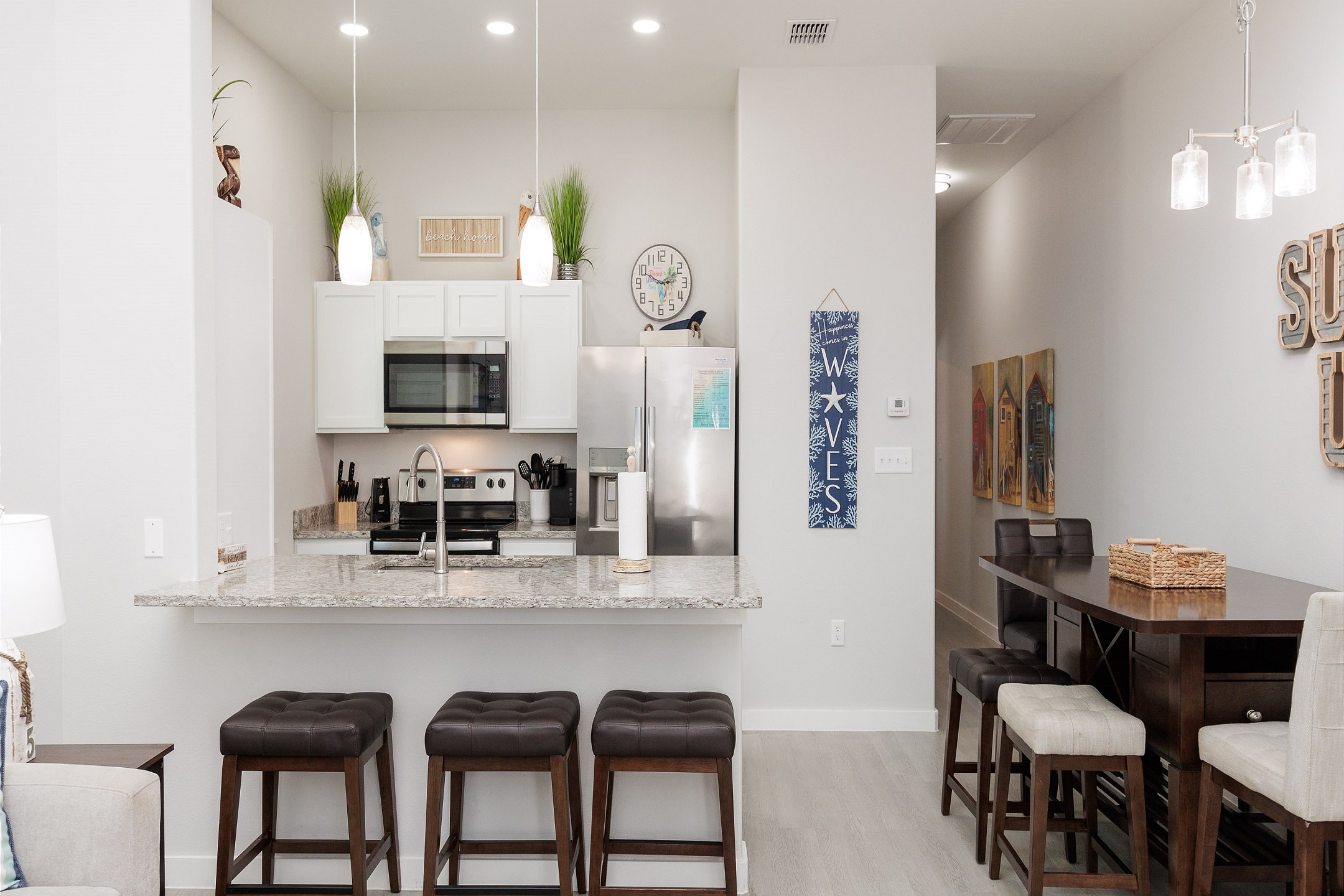 Kitchen and dining area with seating at dining table and bar