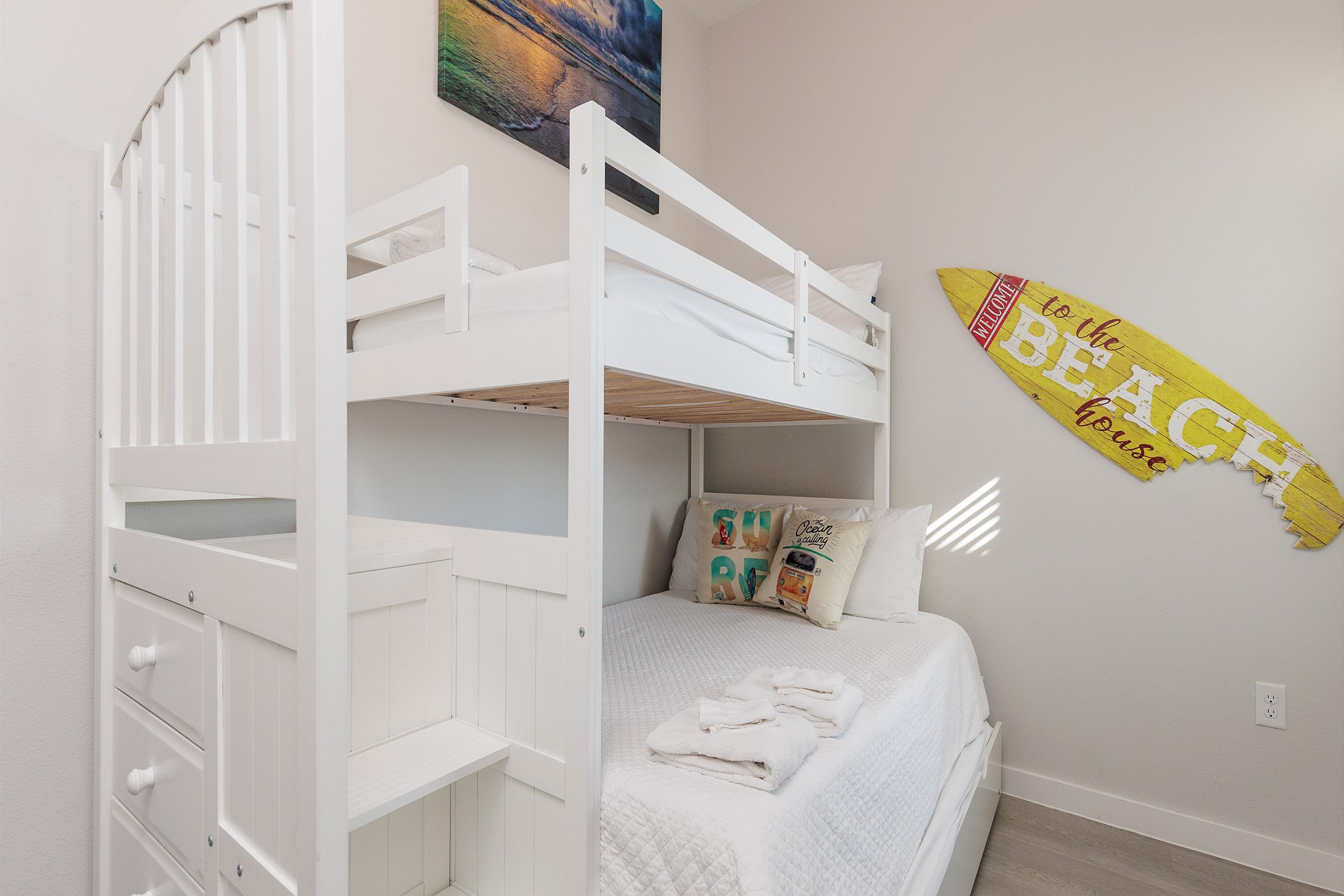 Second bedroom with twin over full size bunk bed with twin trundle, flat screen TV and surfing themed decor 