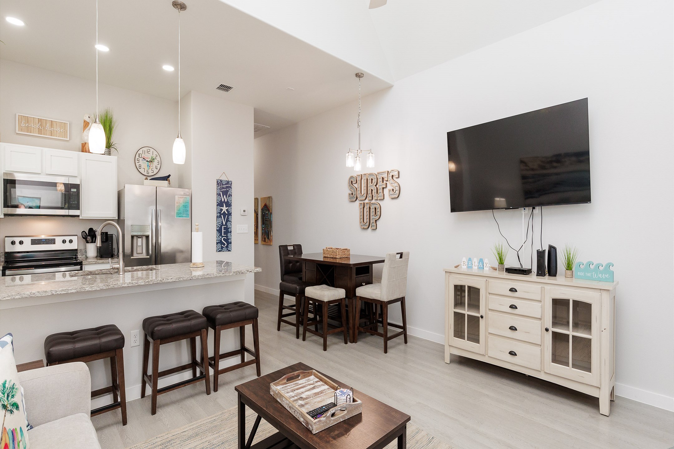 The kitchen, dining, and living areas blend together seamlessly for a bright and airy feel