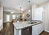 Kitchen area with plenty of counter space and dishwasher 