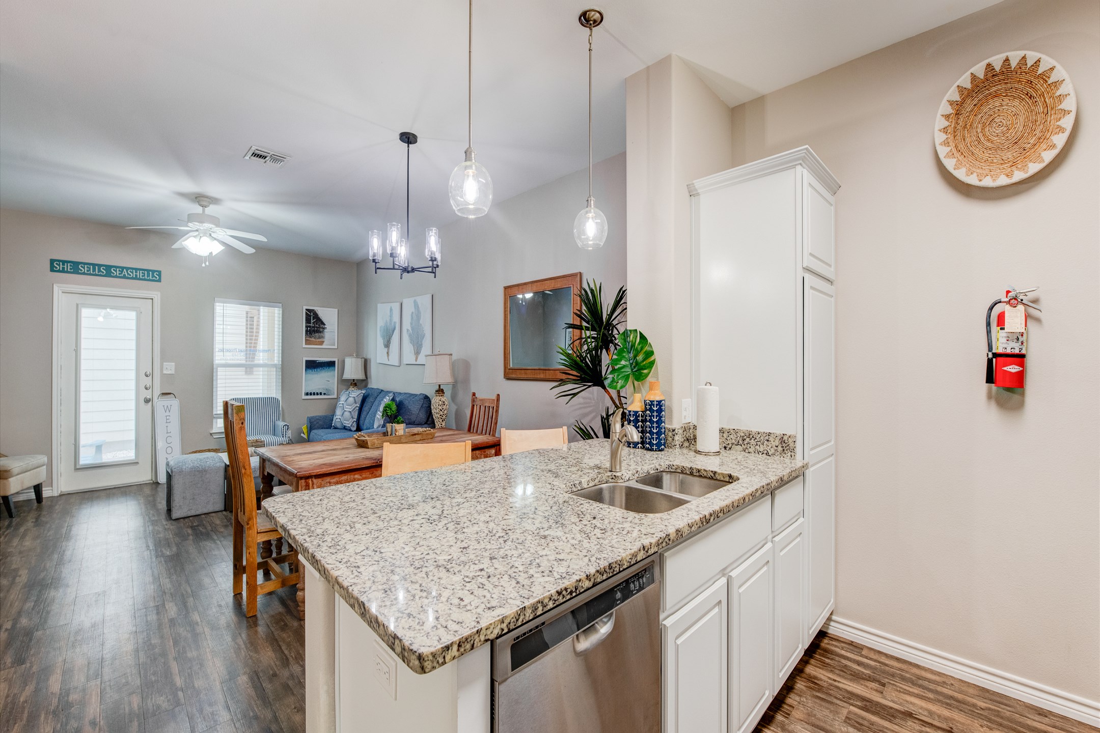 Kitchen area with plenty of counter space and dishwasher that over looks the newly updated living space for family gatherings