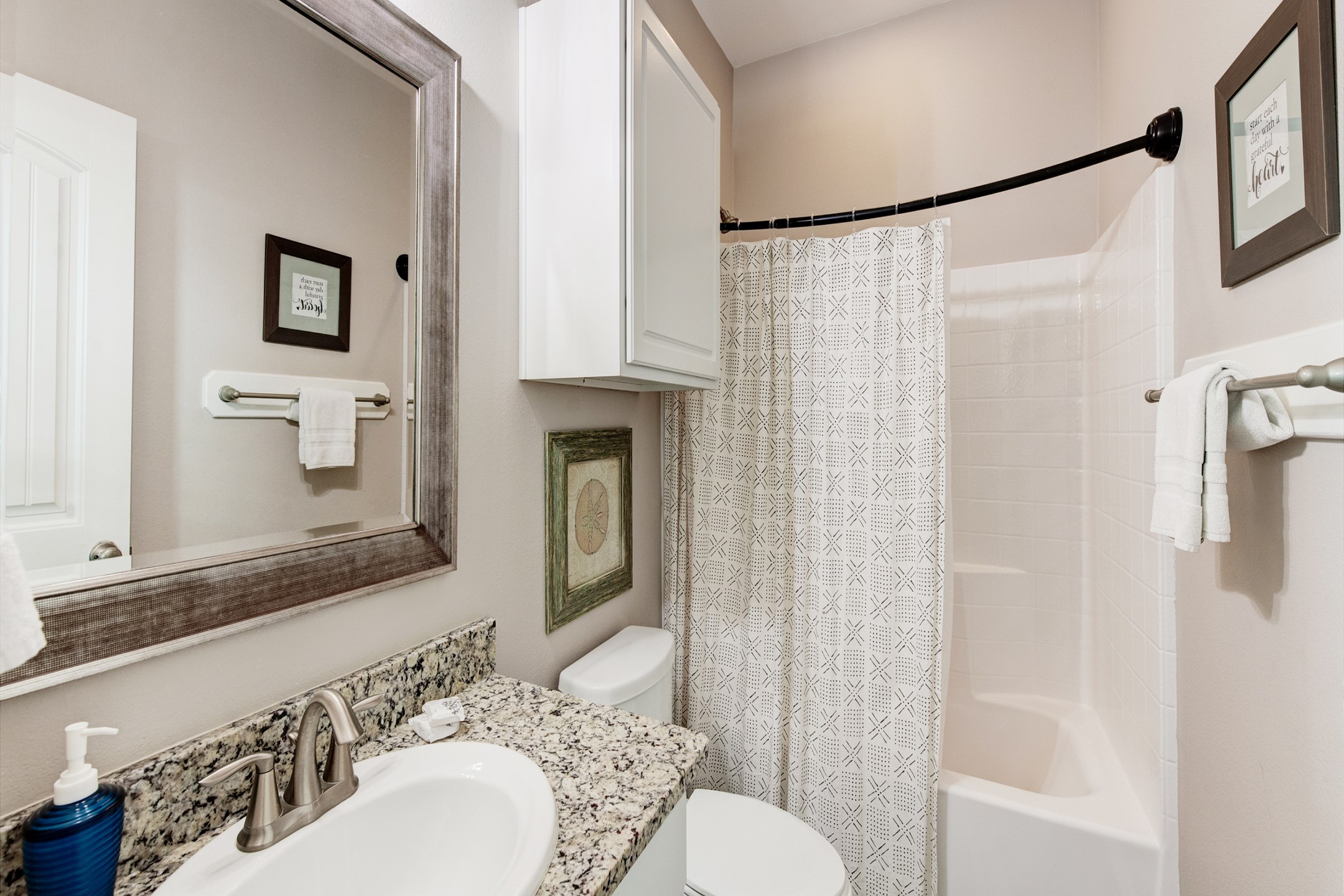 Guest bathroom on the first floor with sink and tub/shower combo 