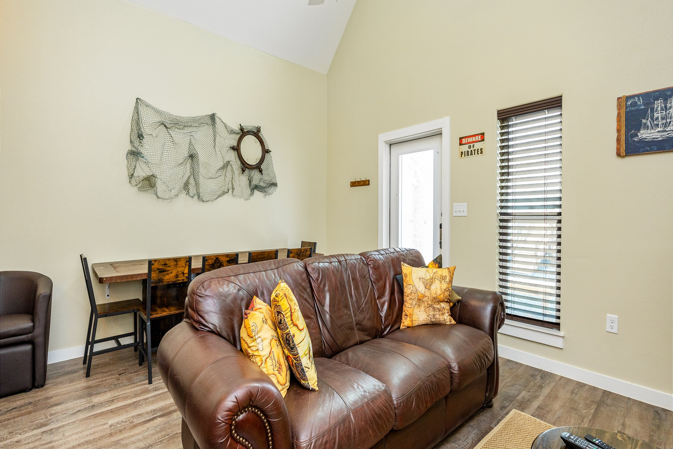 A bright living area featuring a queen-size sofa sleeper and ample seating for all your shipmates